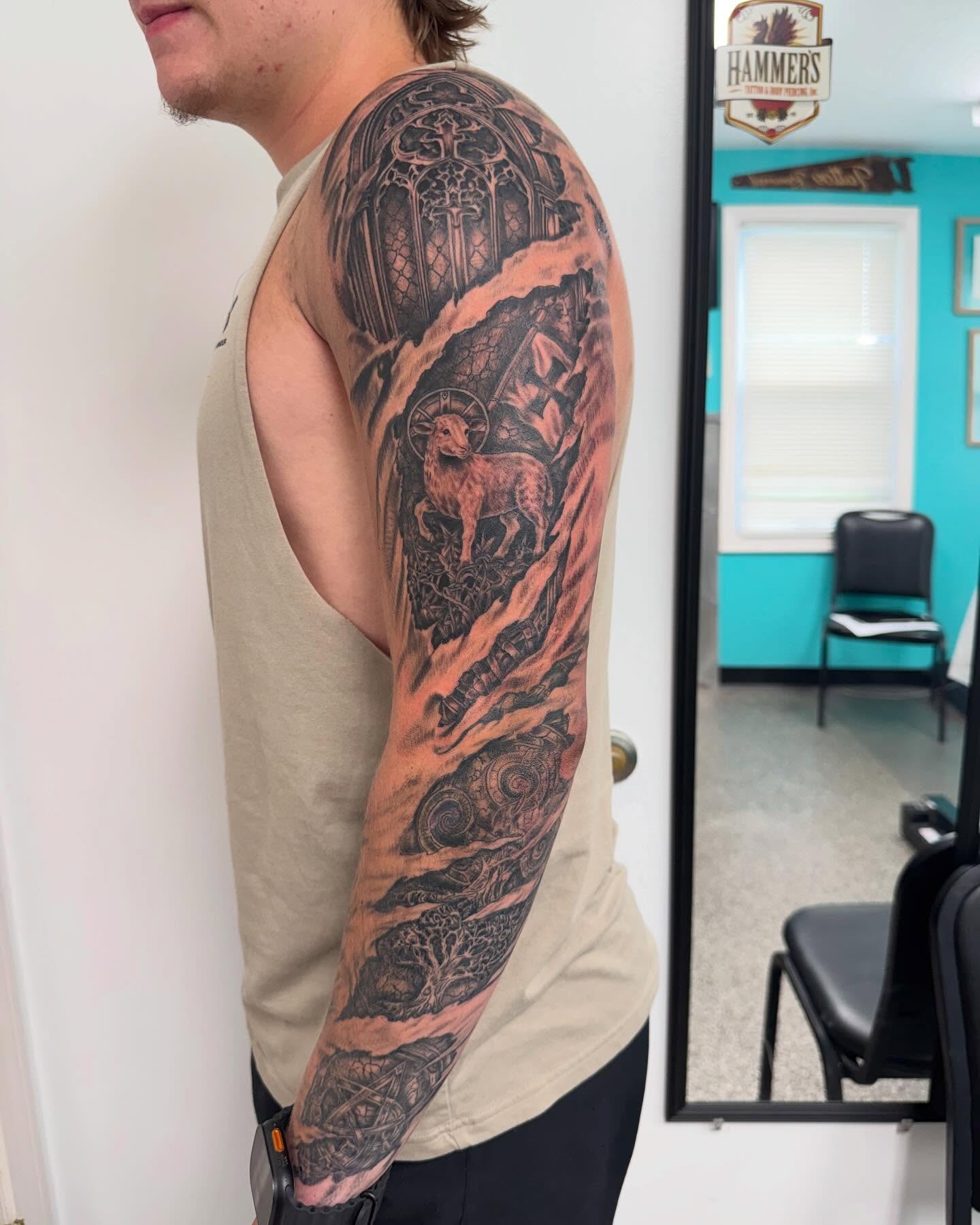 Religious symbolism realism tattoo on the upper arm by Brazun Locker Poloschan
