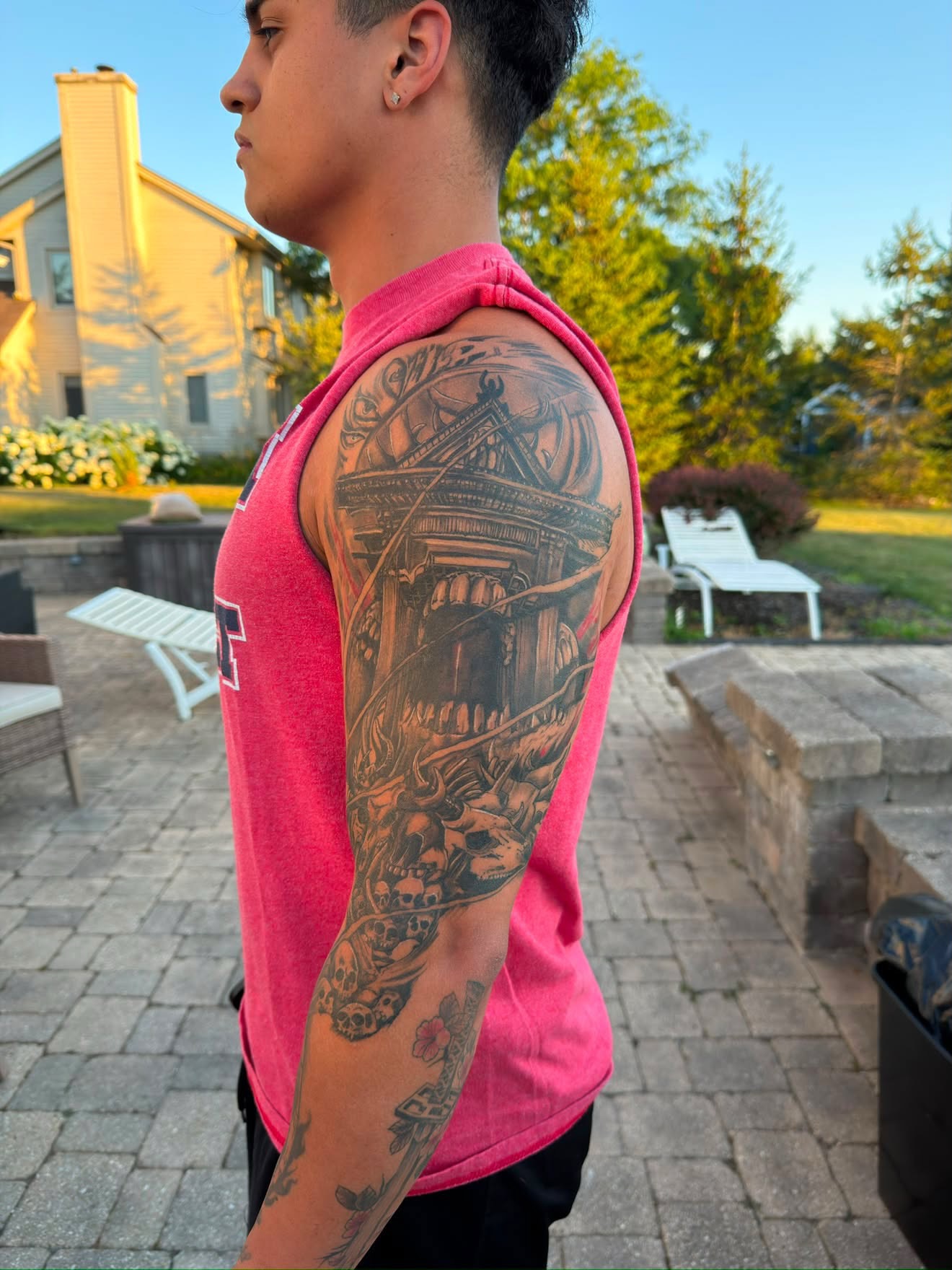 Temple and dragon American traditional tattoo on the upper arm by Daniel Illachek