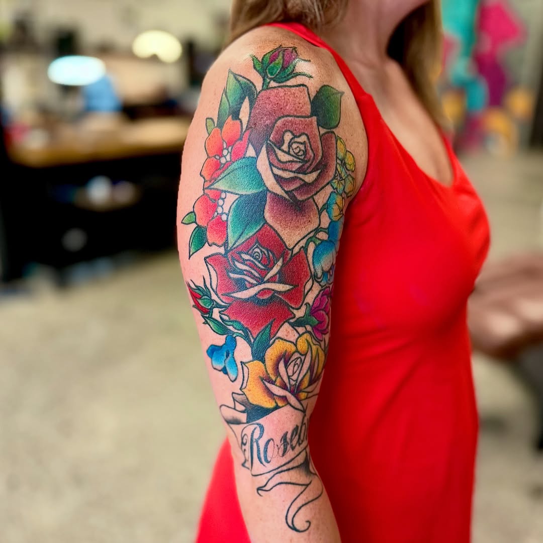 Roses American traditional tattoo on the upper arm by Jamie Hall, Kansas City, Missouri