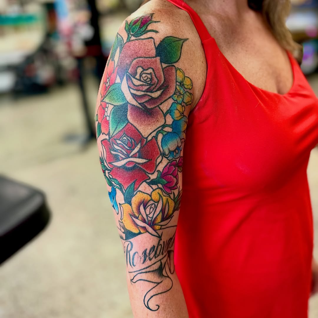 Roses American traditional tattoo on the upper arm by Jamie Hall, Kansas City, Missouri