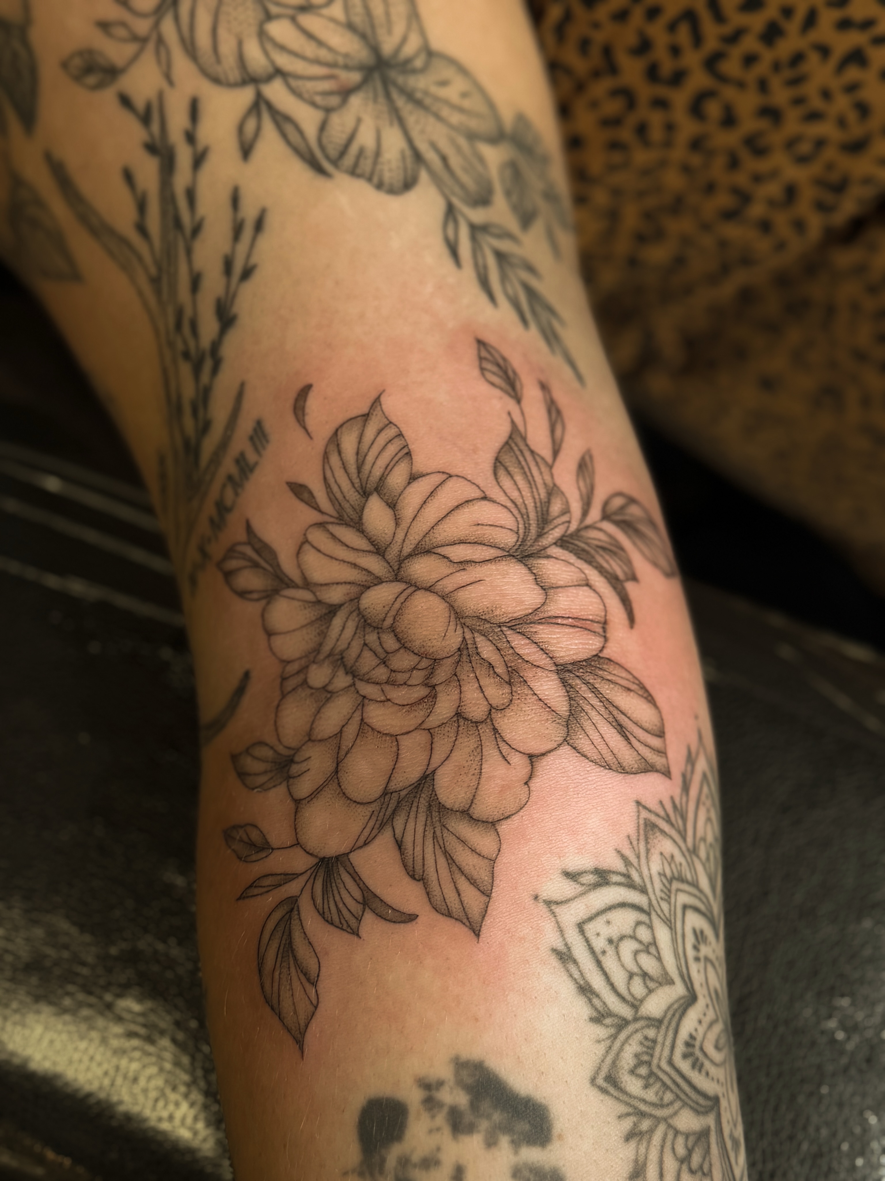 Floral bouquet black and grey tattoo on the forearm by Courtney