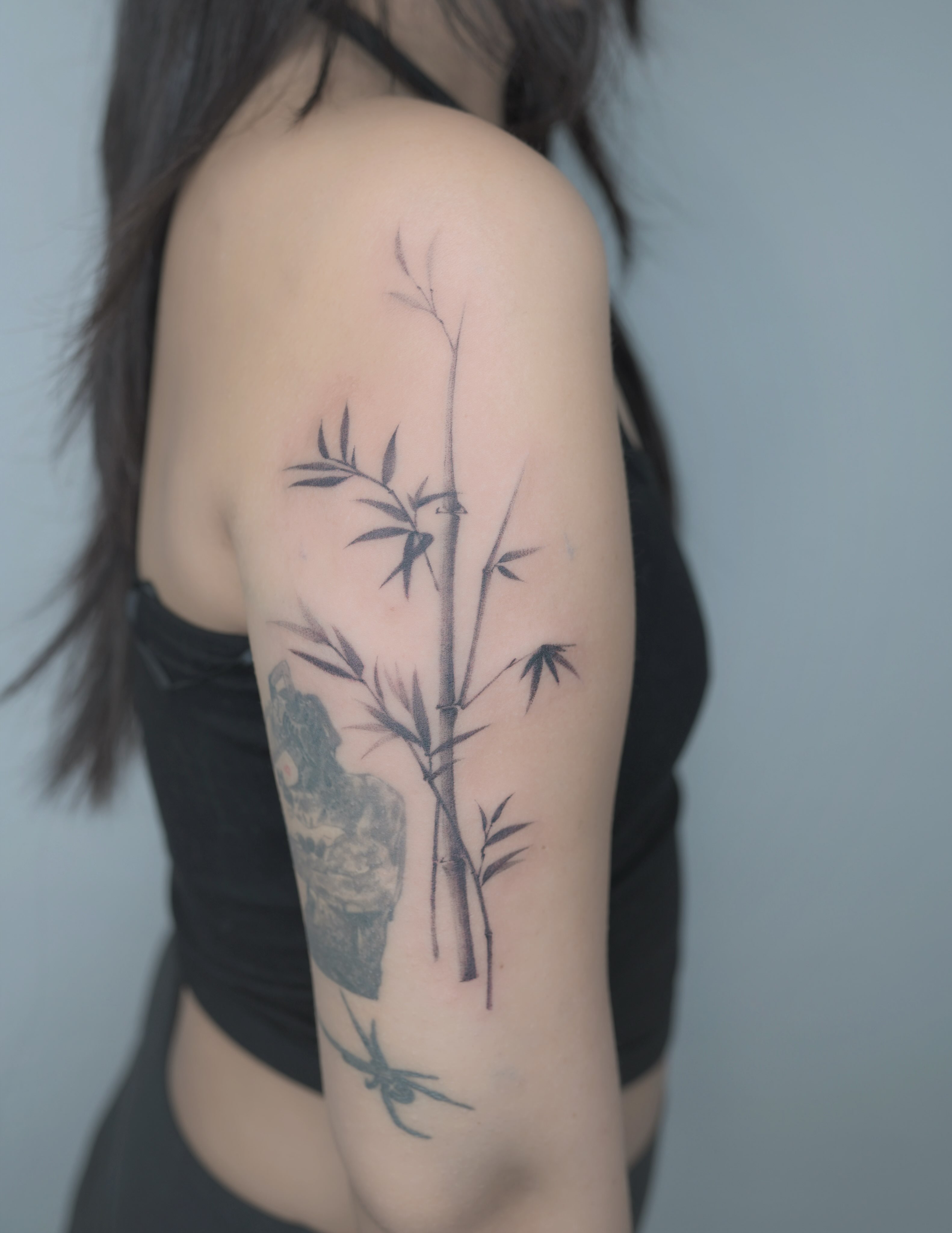 Bamboo black and grey tattoo on the upper arm by Seattle tattoo artist-Mia