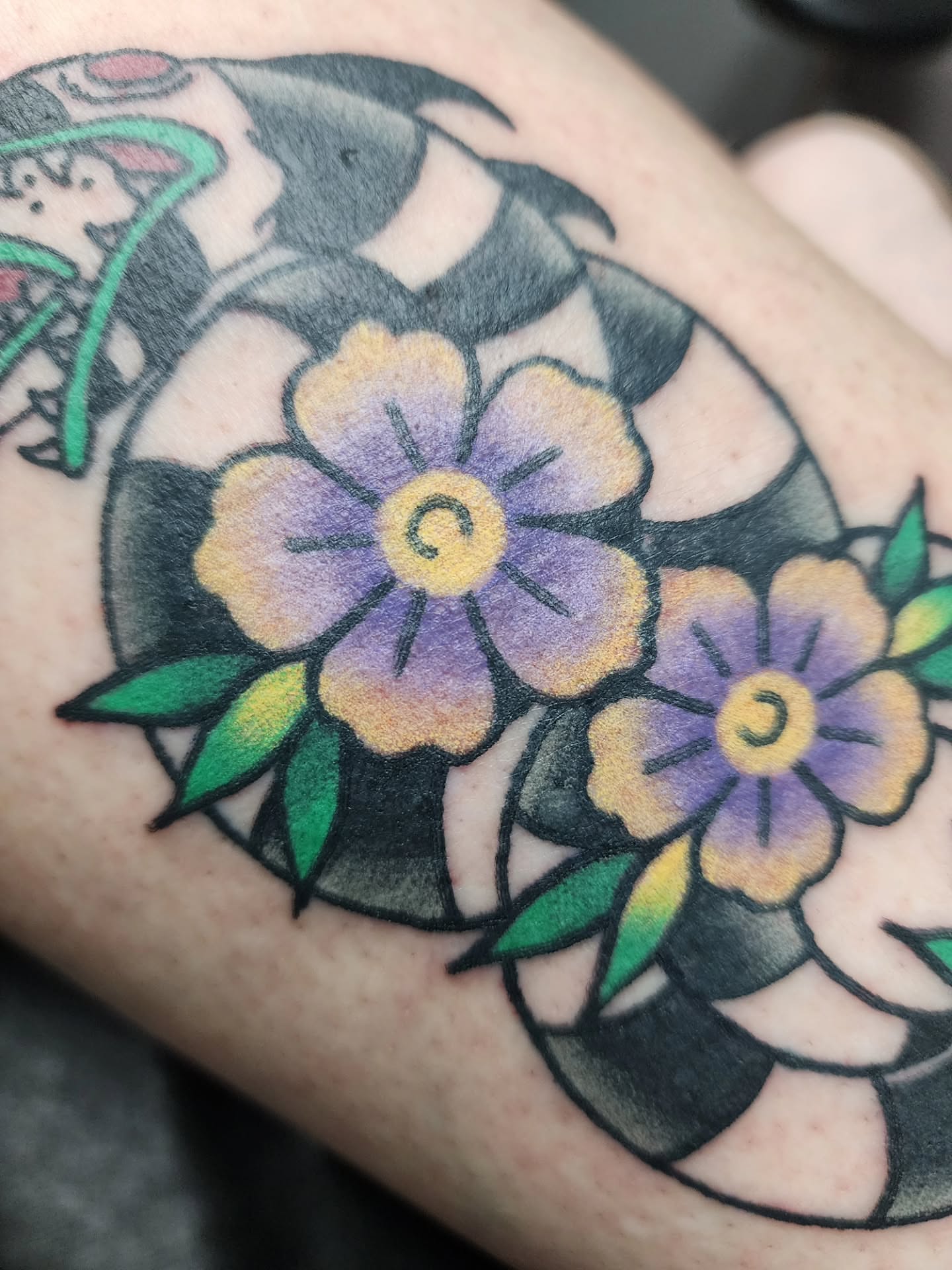 Purple flowers American traditional tattoo on the forearm by Meggalodon 🖤 (Meggan Rose)
