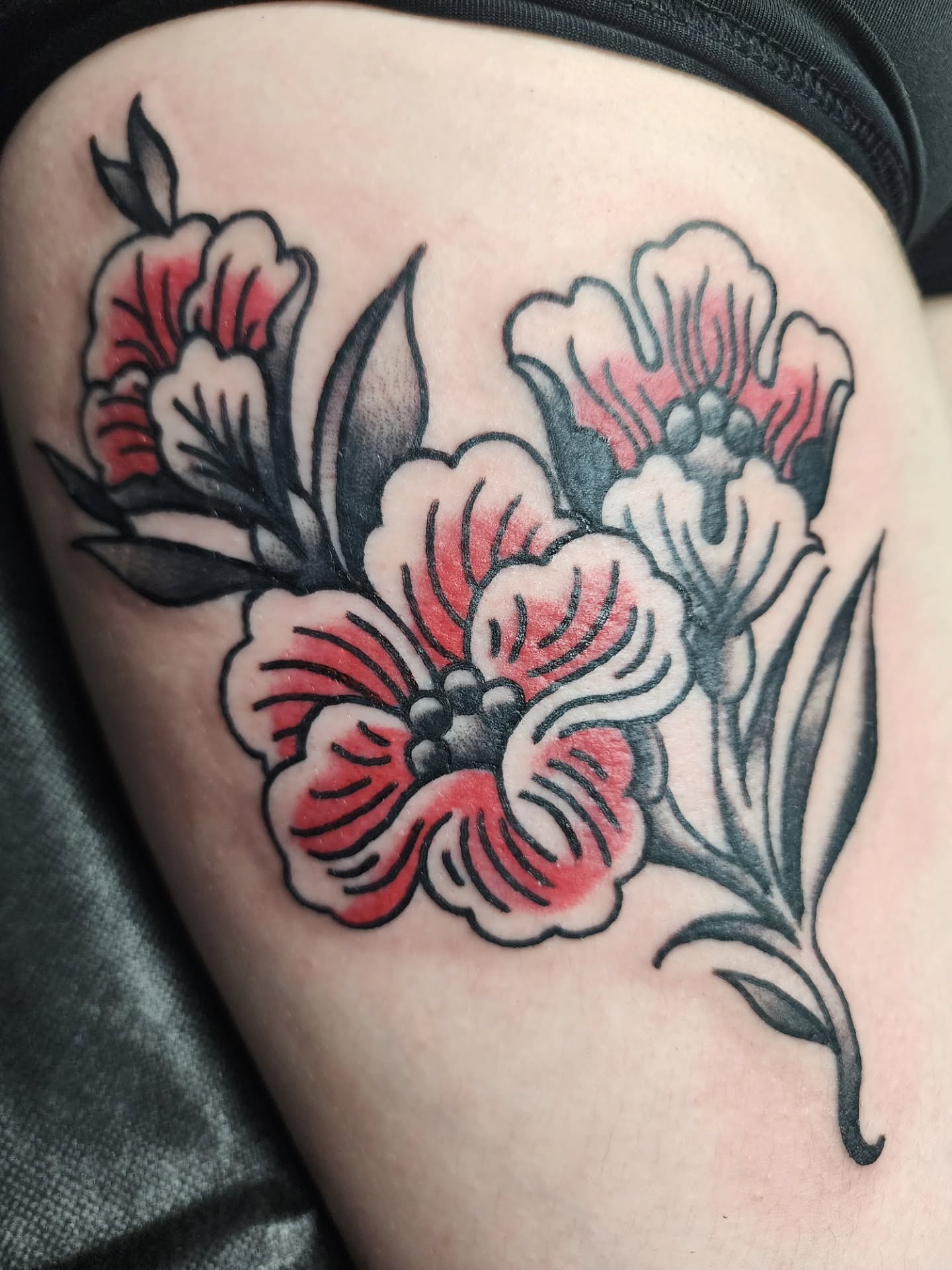 Flowers American traditional tattoo on the thigh by Meggalodon 🖤 (Meggan Rose)
