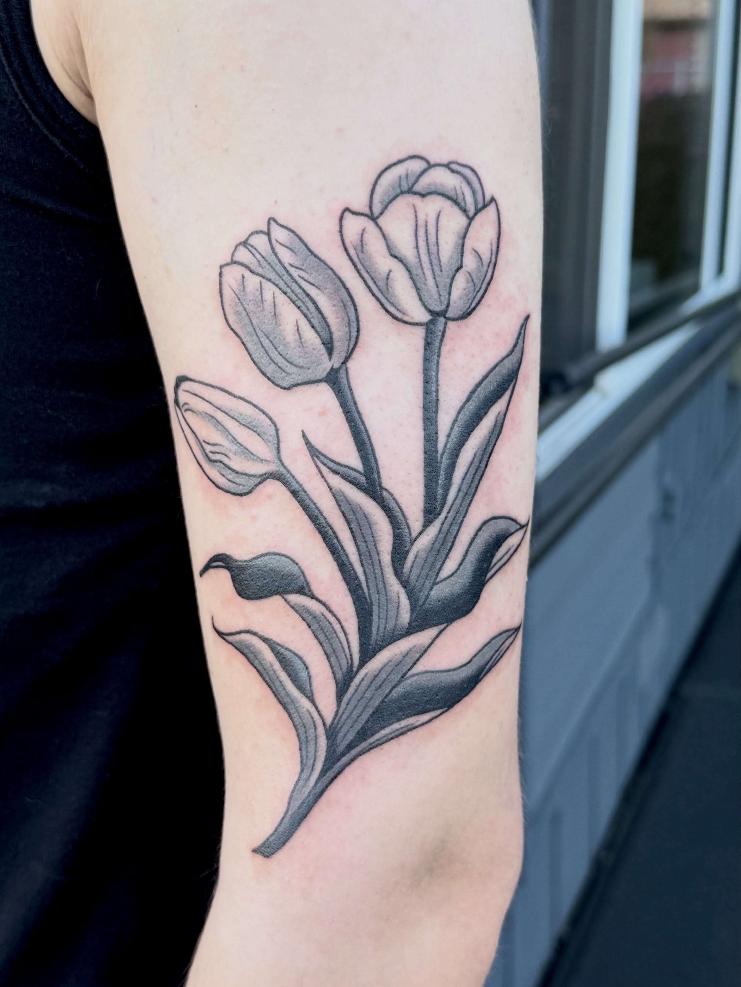 Tulips black and grey tattoo on the forearm by Nia (Knee-uhh) 🦷