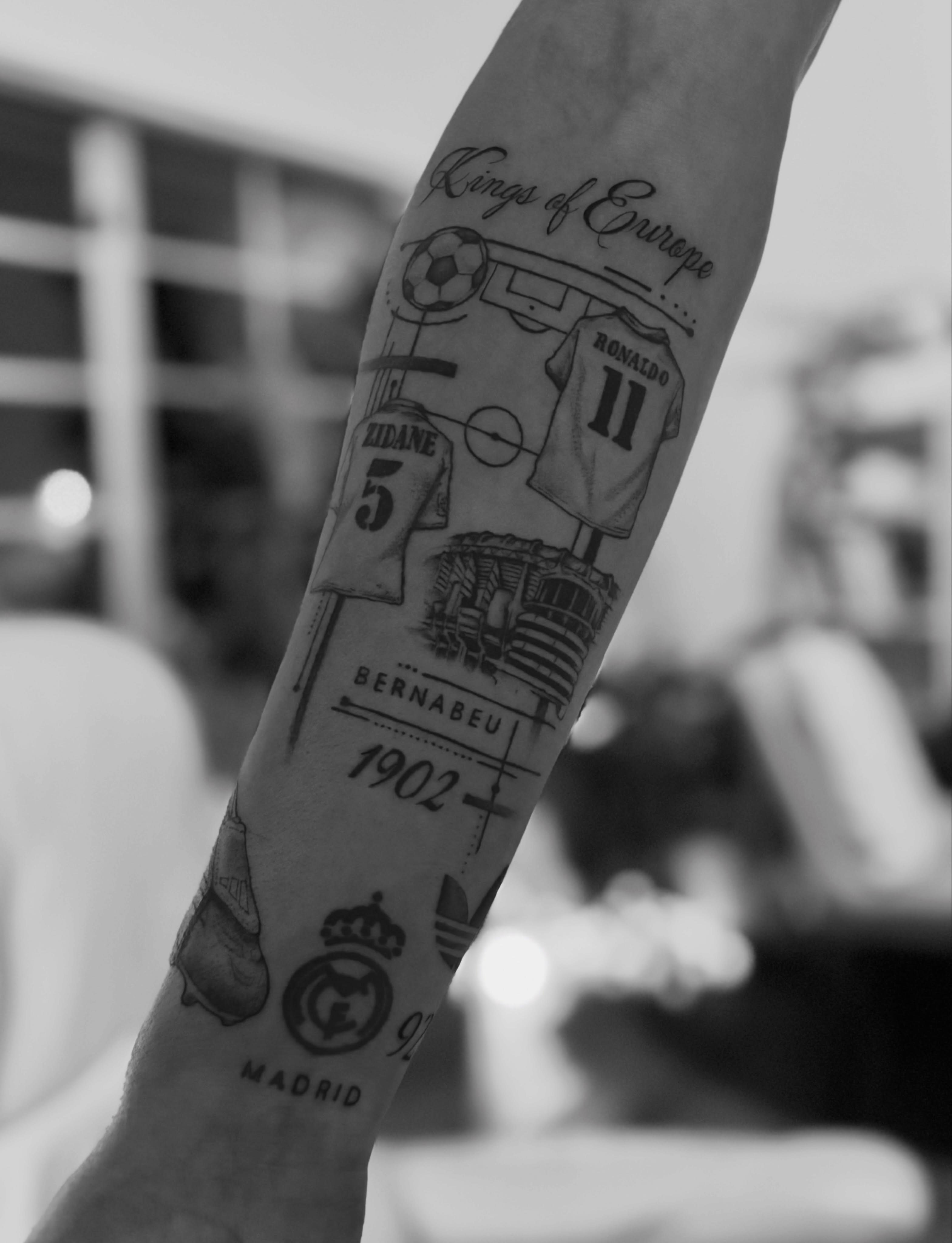 Soccer-themed black and grey tattoo on the forearm by @secretlinetattoo