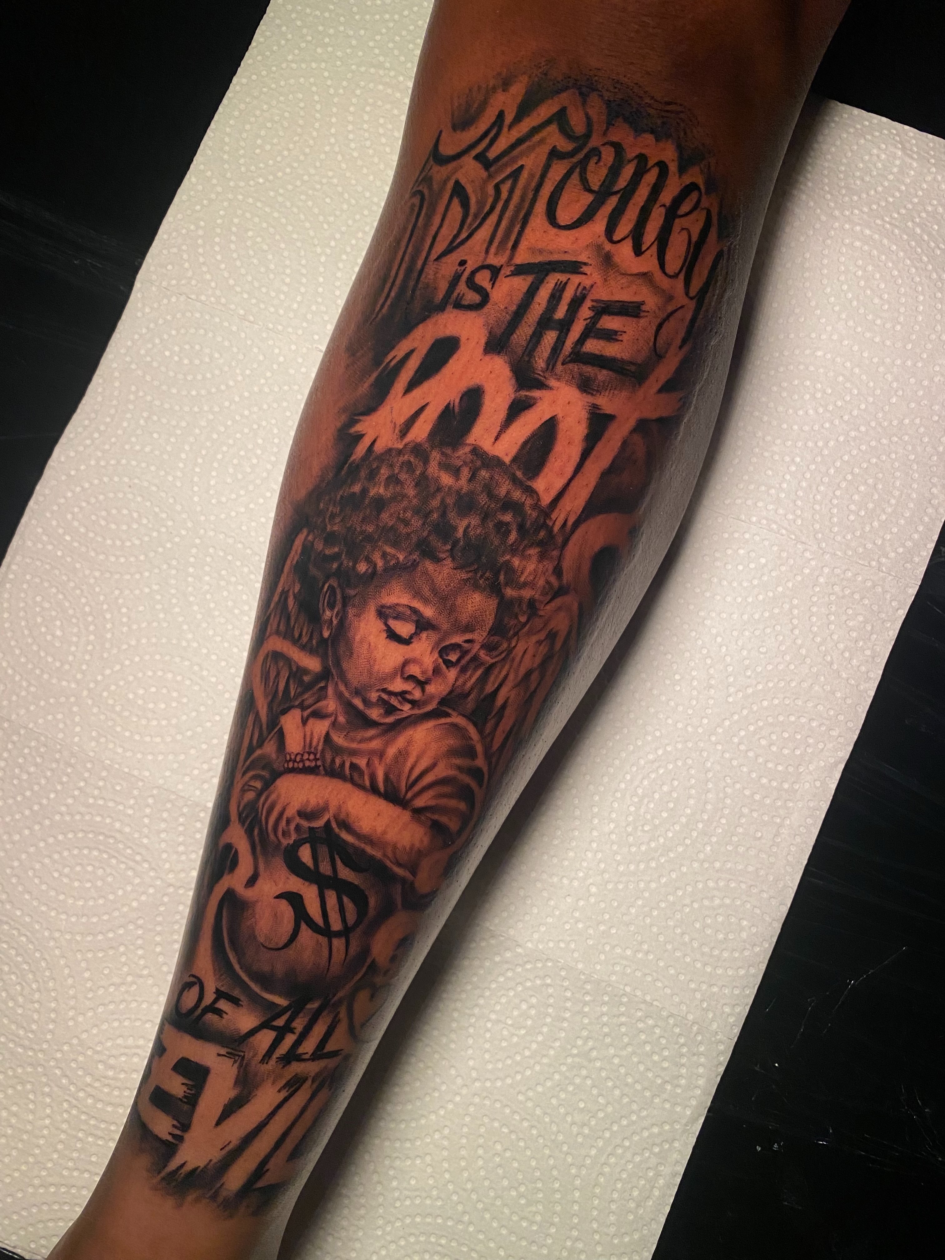 Child and $ symbol black and grey tattoo on the forearm by Tattoo Artist