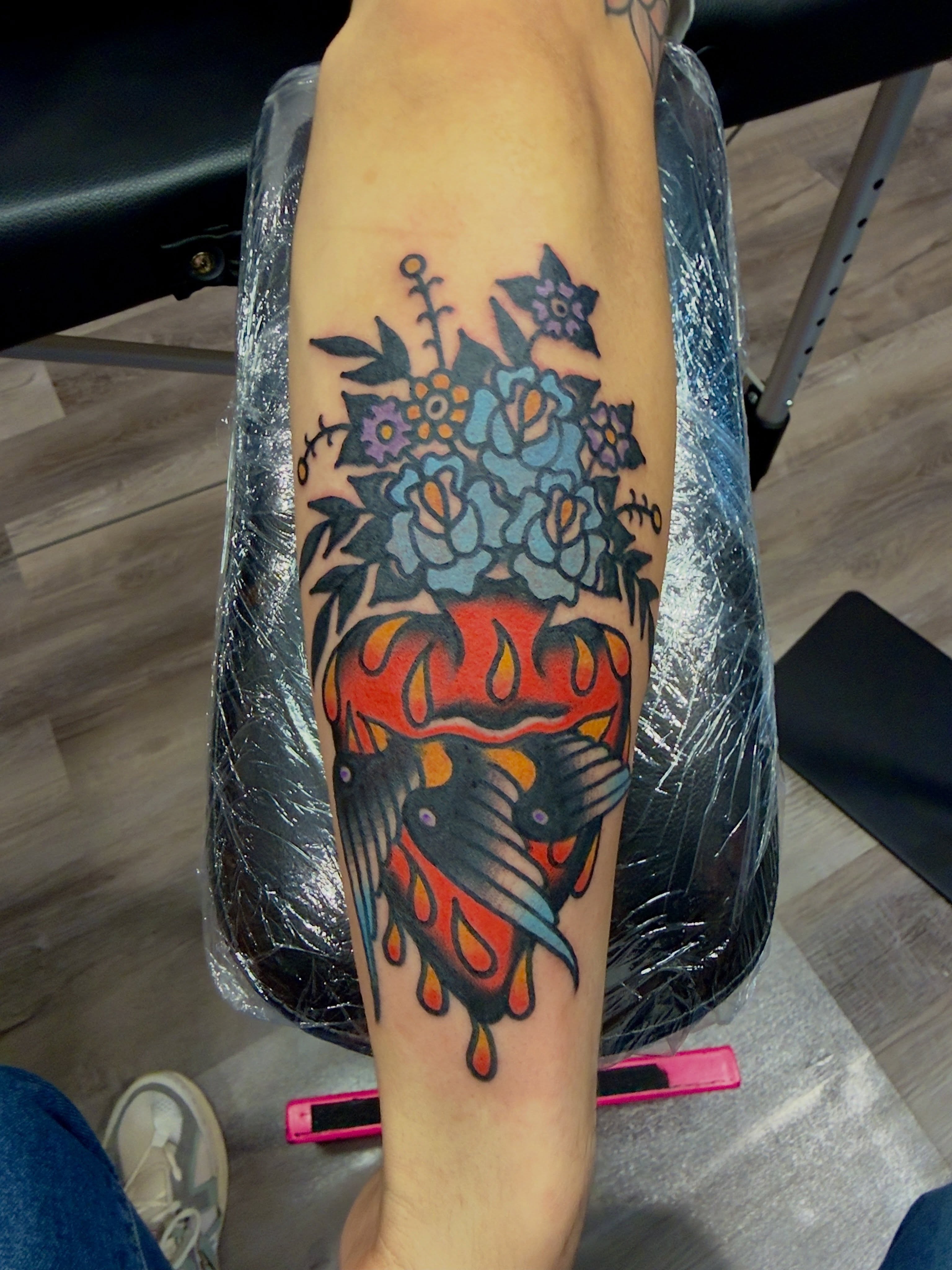 Floral bouquet American traditional tattoo on the forearm by Jimmy Kelley
