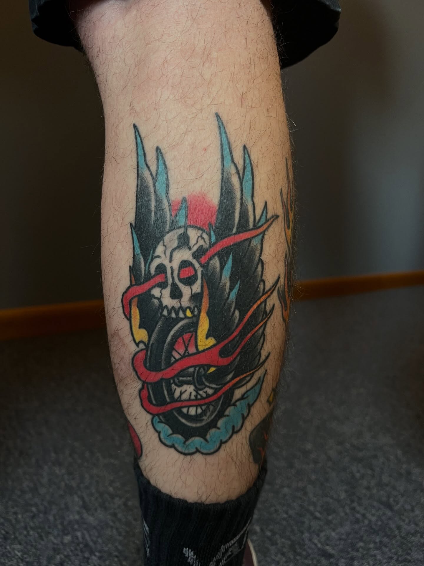 Skull with flames American traditional tattoo on the forearm by Tyler Van Pelt