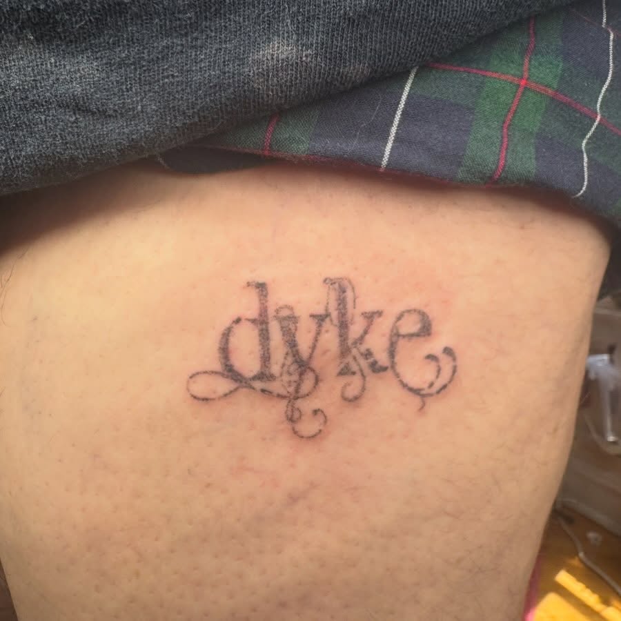 Dyke lettering script tattoo on the thigh by mar