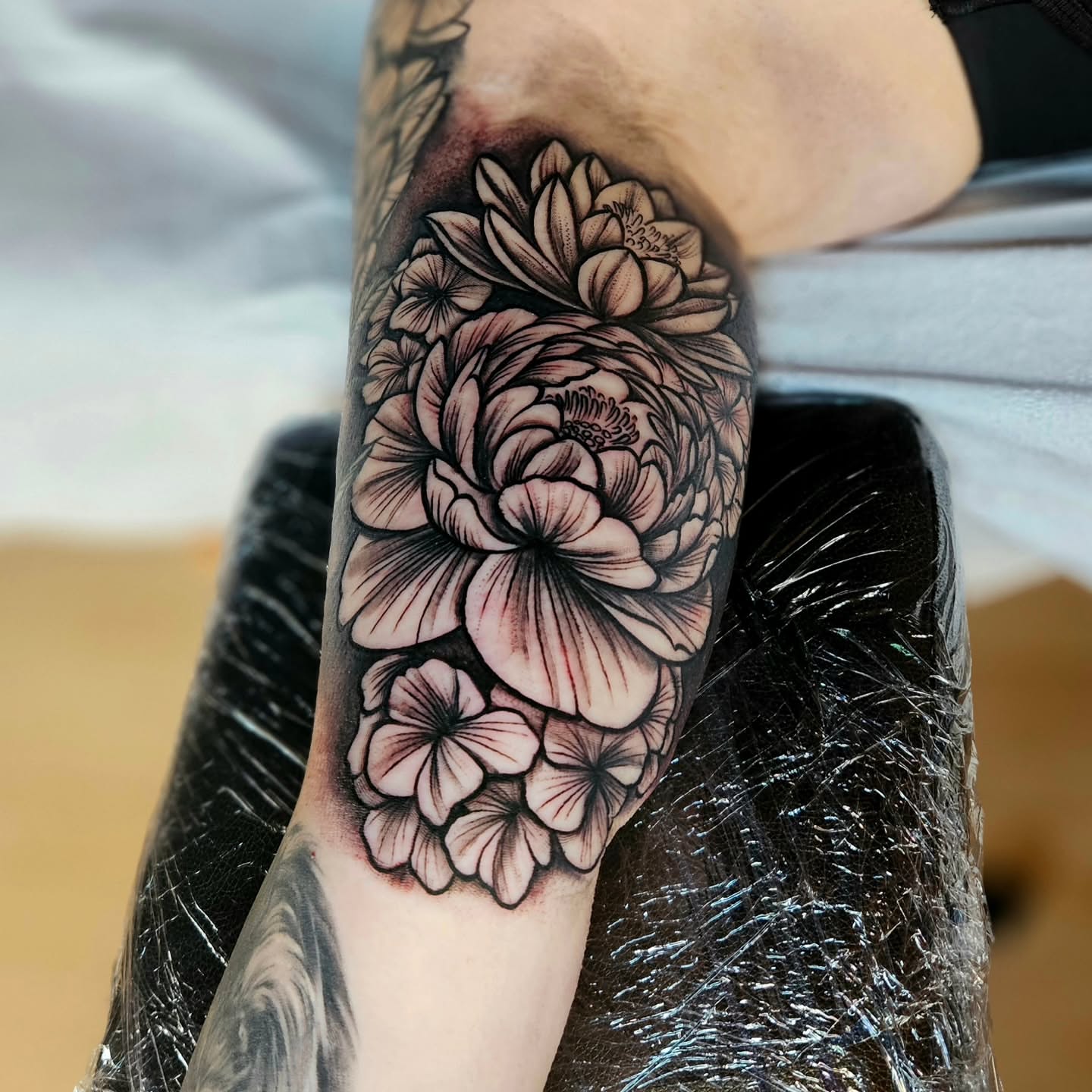 Floral bouquet realism tattoo on the forearm by Justin J-rust Smith