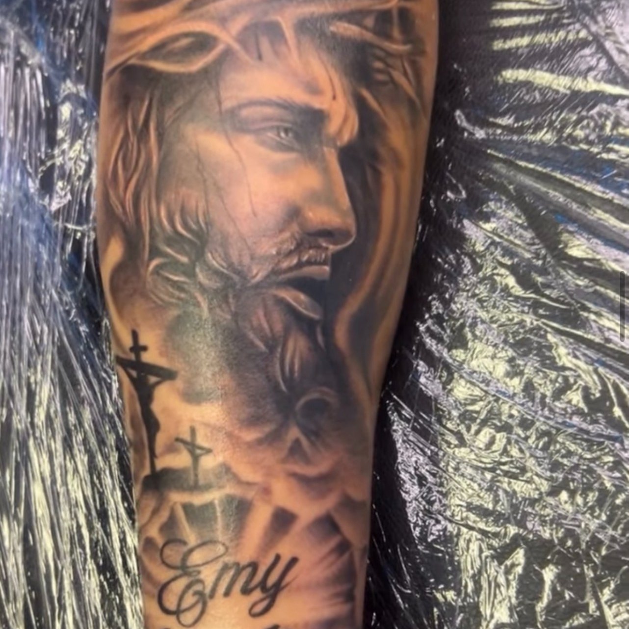 Religious figure realism tattoo on the forearm by Ayanna Luna