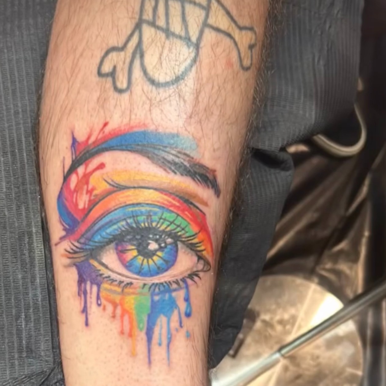 Rainbow eye new school tattoo on the forearm by Ayanna Luna