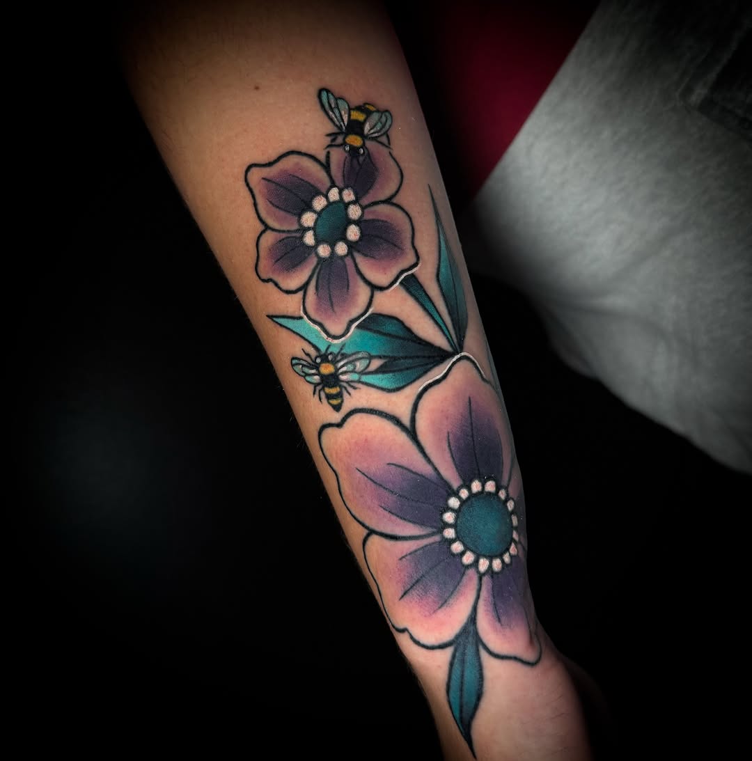 Flowers and bees American traditional tattoo on the forearm by Savannah Duff