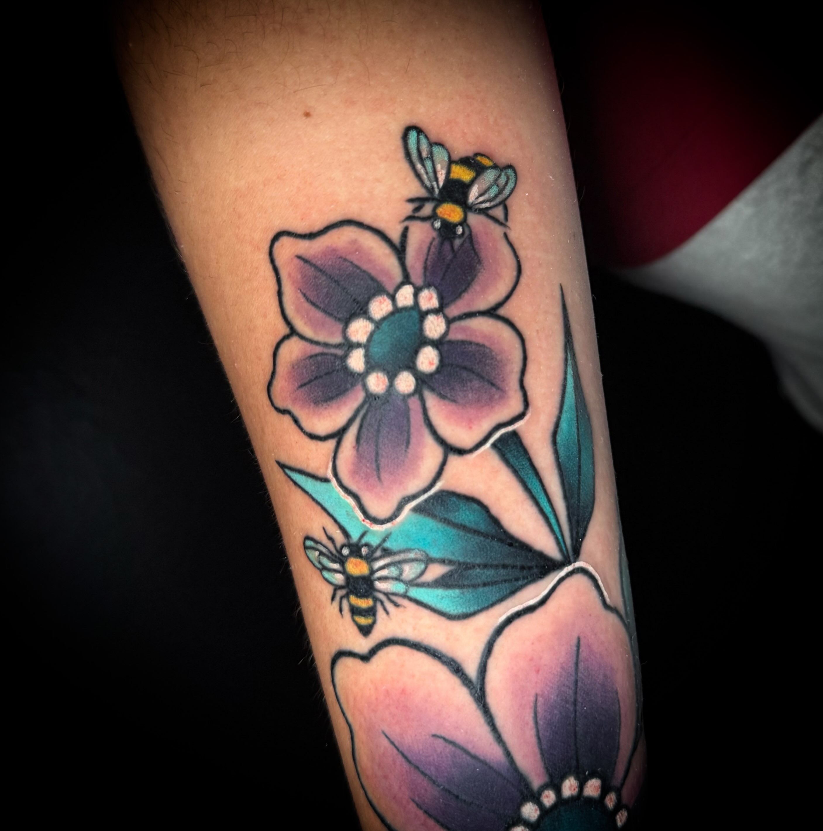 Flower and bee American traditional tattoo on the forearm by Savannah Duff