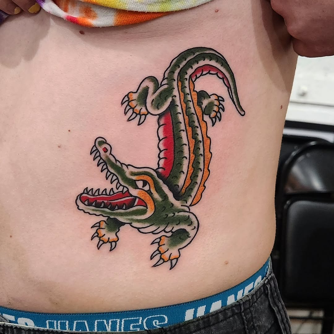Alligator American traditional tattoo on the ribs by Douglas Grady