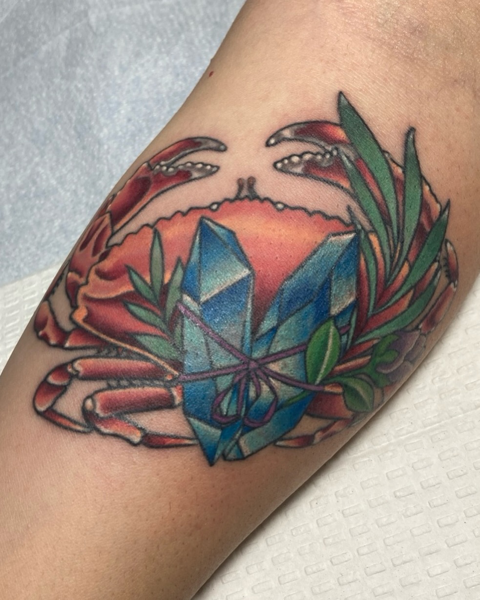 Crab with crystal American traditional tattoo on the forearm by Ashley Antolin
