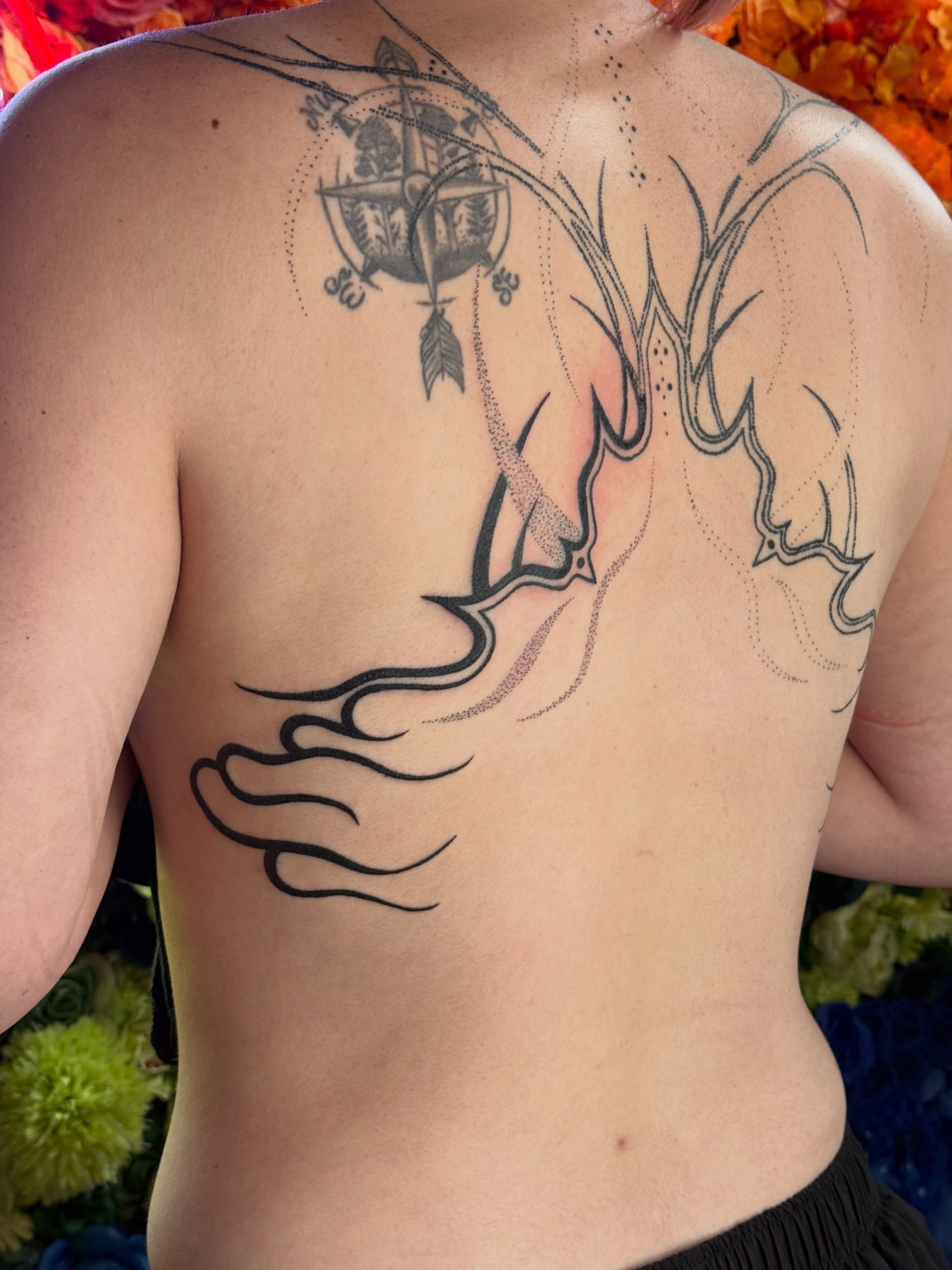Ship and flame dotwork tattoo on the back by Handpoke Tattoo Artist, Minneapolis, Minnesota