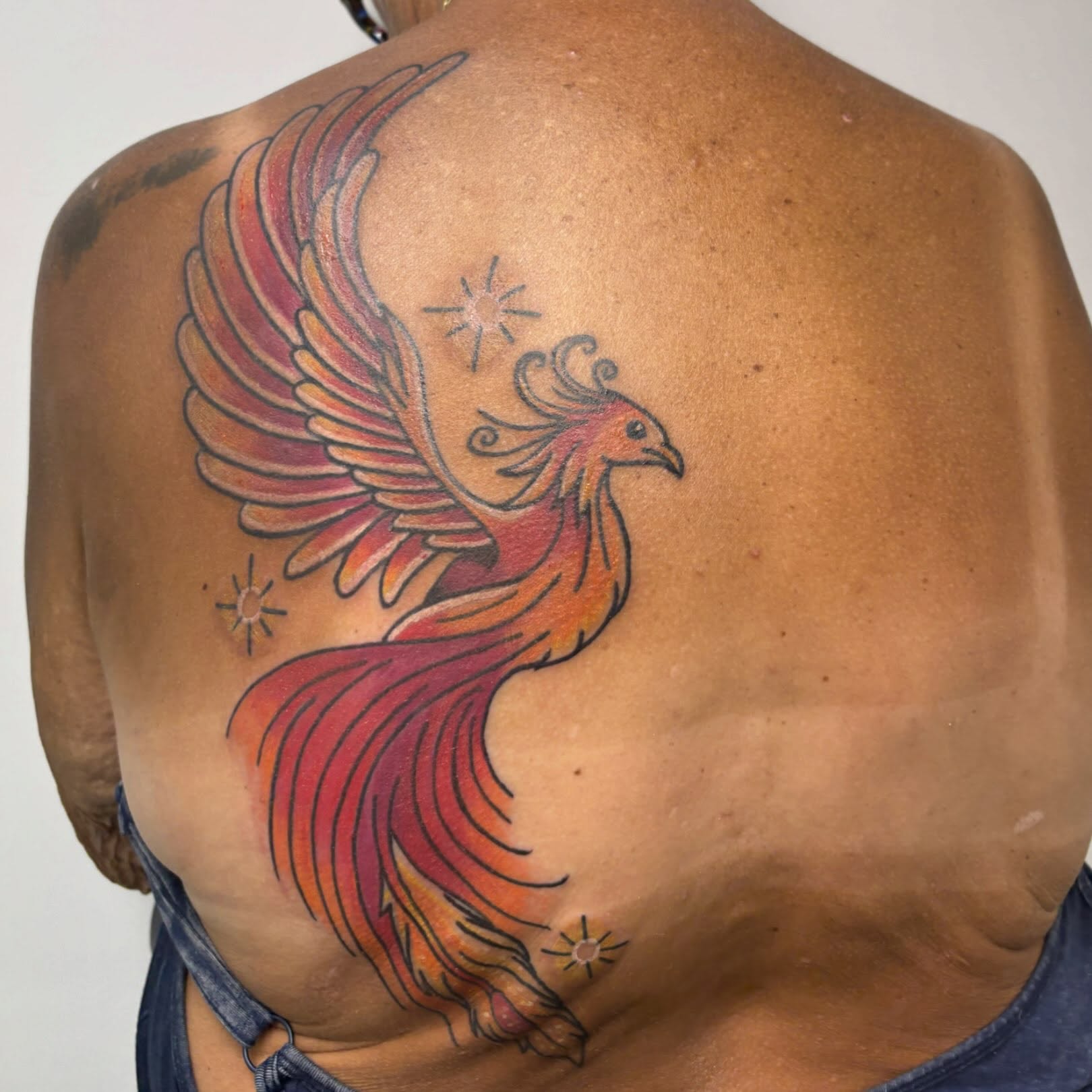 Phoenix new school tattoo on the back by Taylor  Thompson