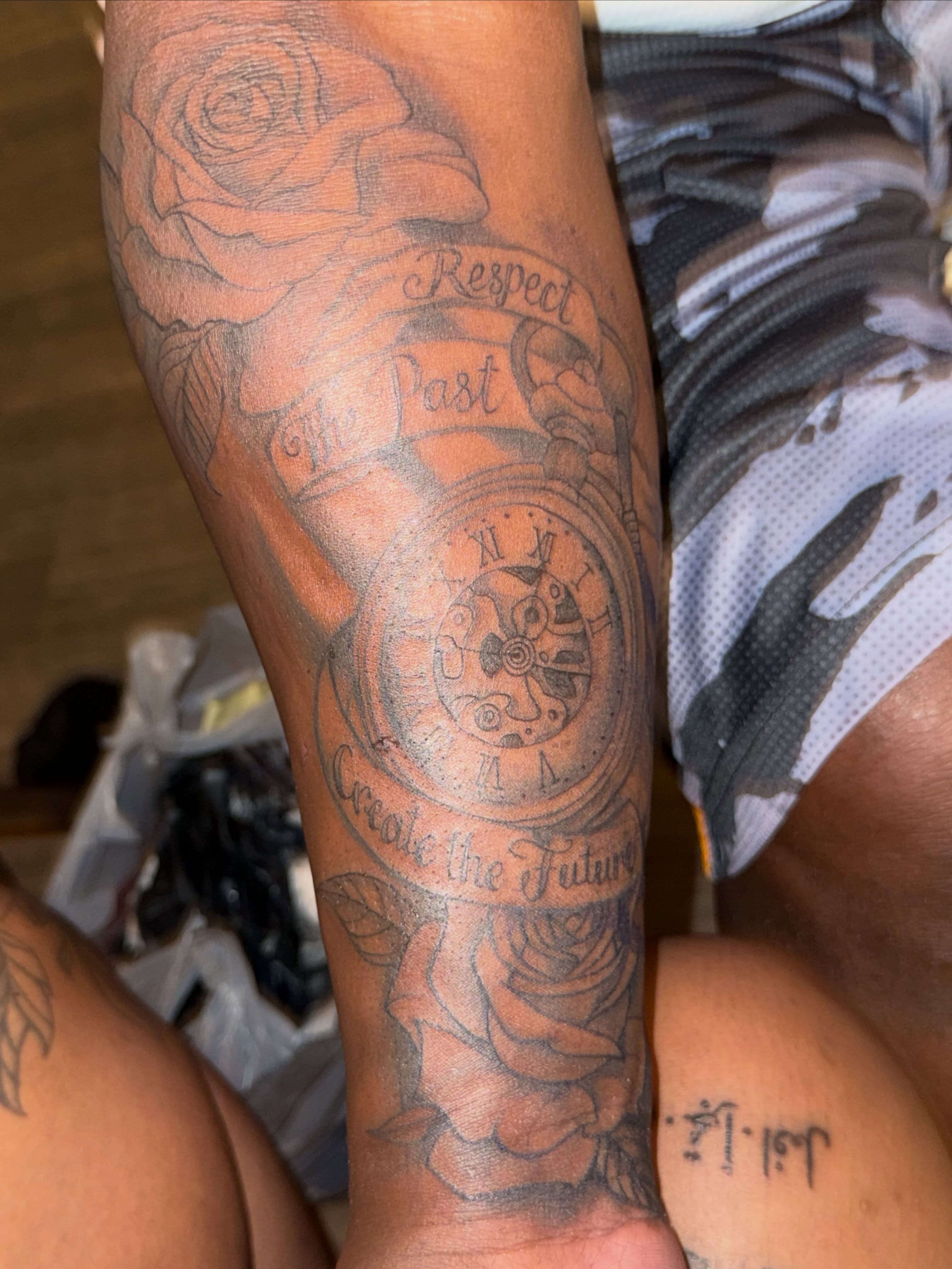 Clock and roses black and grey tattoo on the forearm by Aja Marie