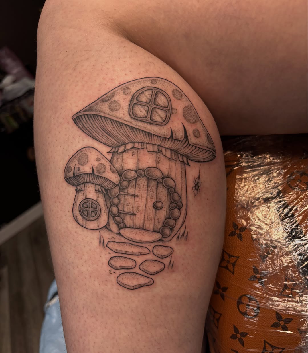 Mushroom house dotwork tattoo on the thigh by Hailey Nicole