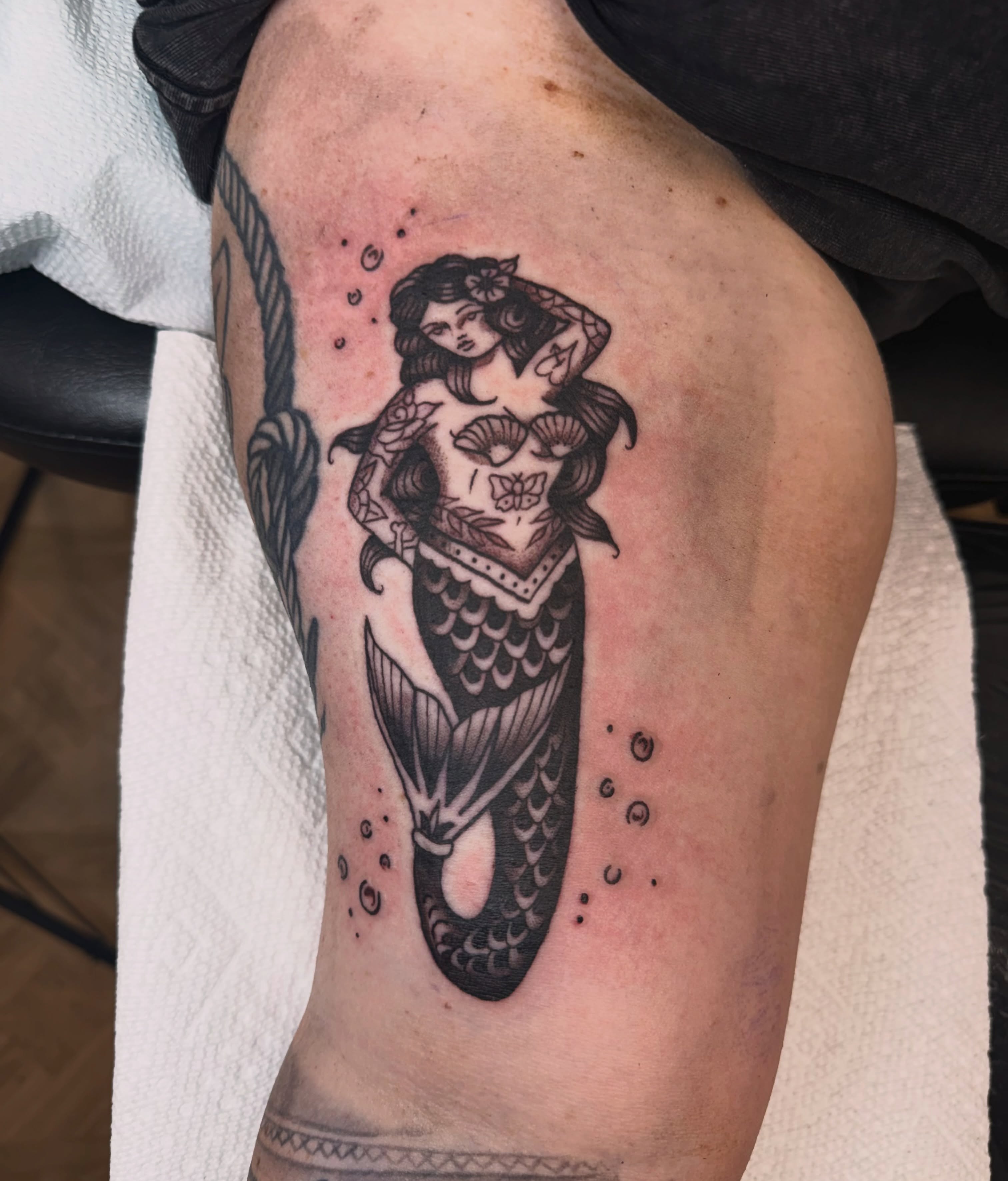 Mermaid American traditional tattoo on the thigh by Emmie Turner