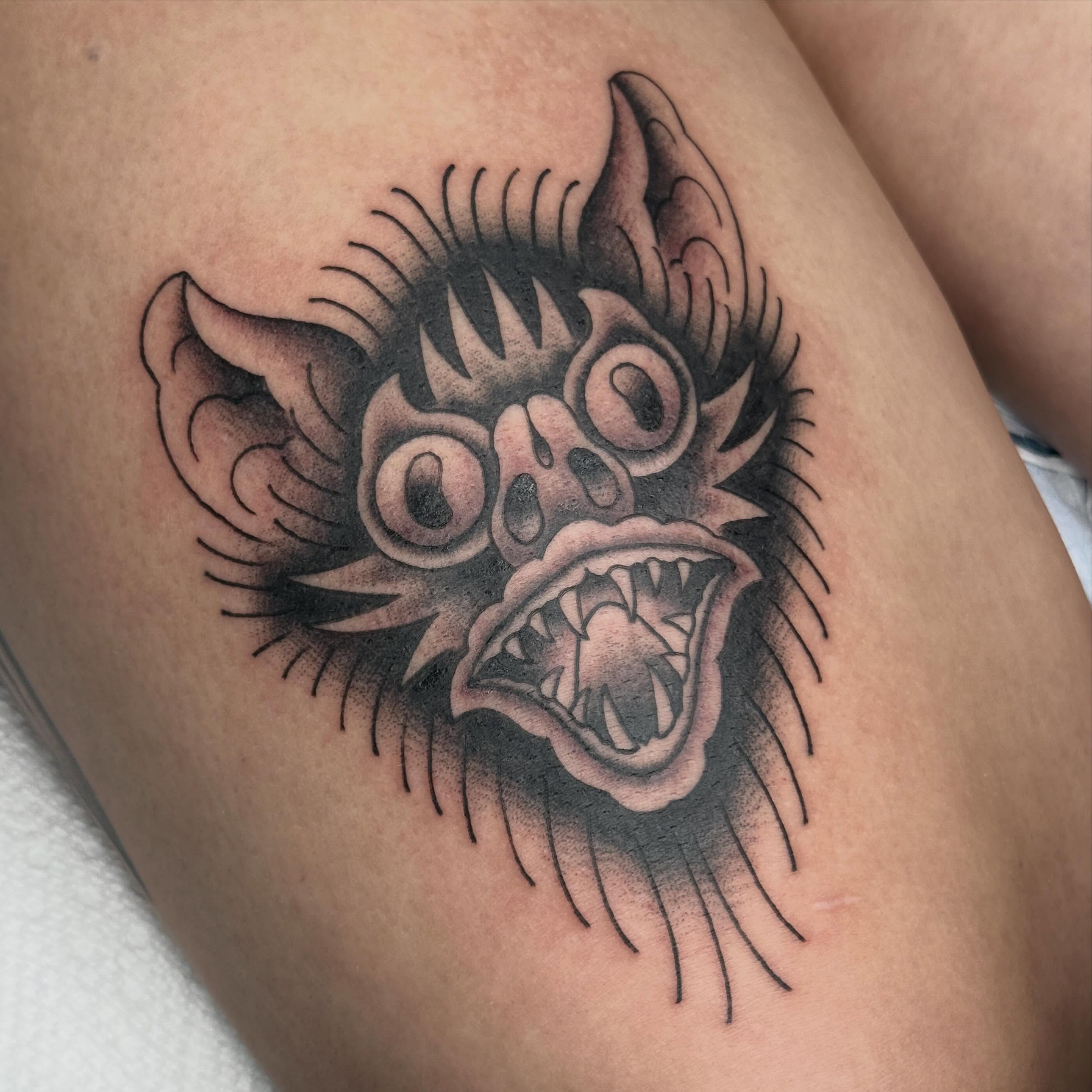 Demon face black and grey tattoo on the thigh by chloe jeanel estrada
