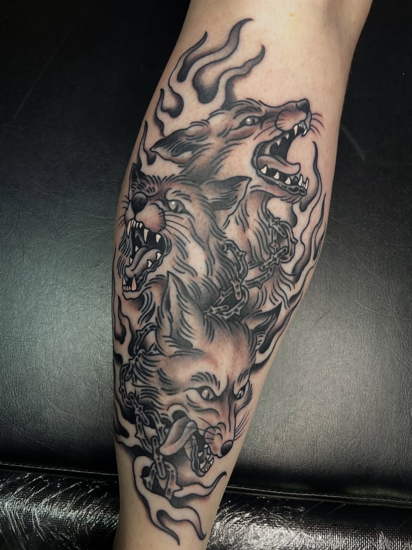 Three wolves American traditional tattoo on the forearm by Tom Taylor, Philadelphia, Pennsylvania
