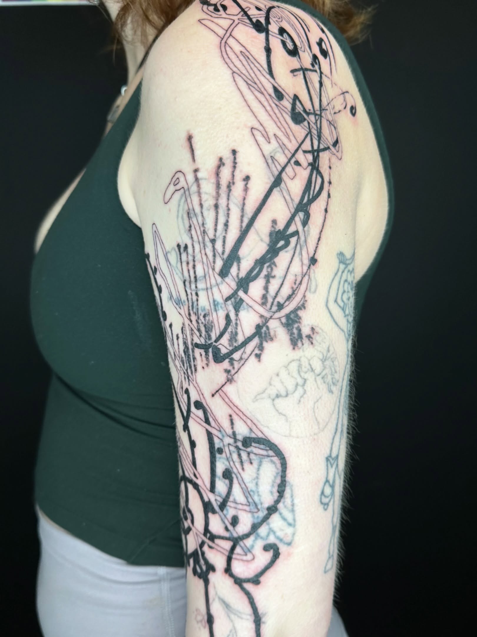 Abstract design tattoo on the upper arm by reid - tattoo artist