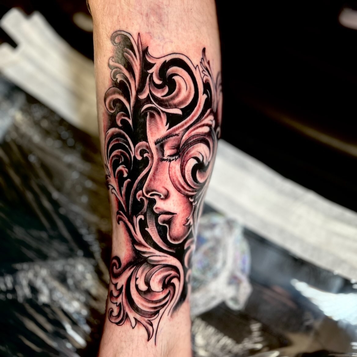 Woman's face ornamental tattoo on the forearm by Austin Young