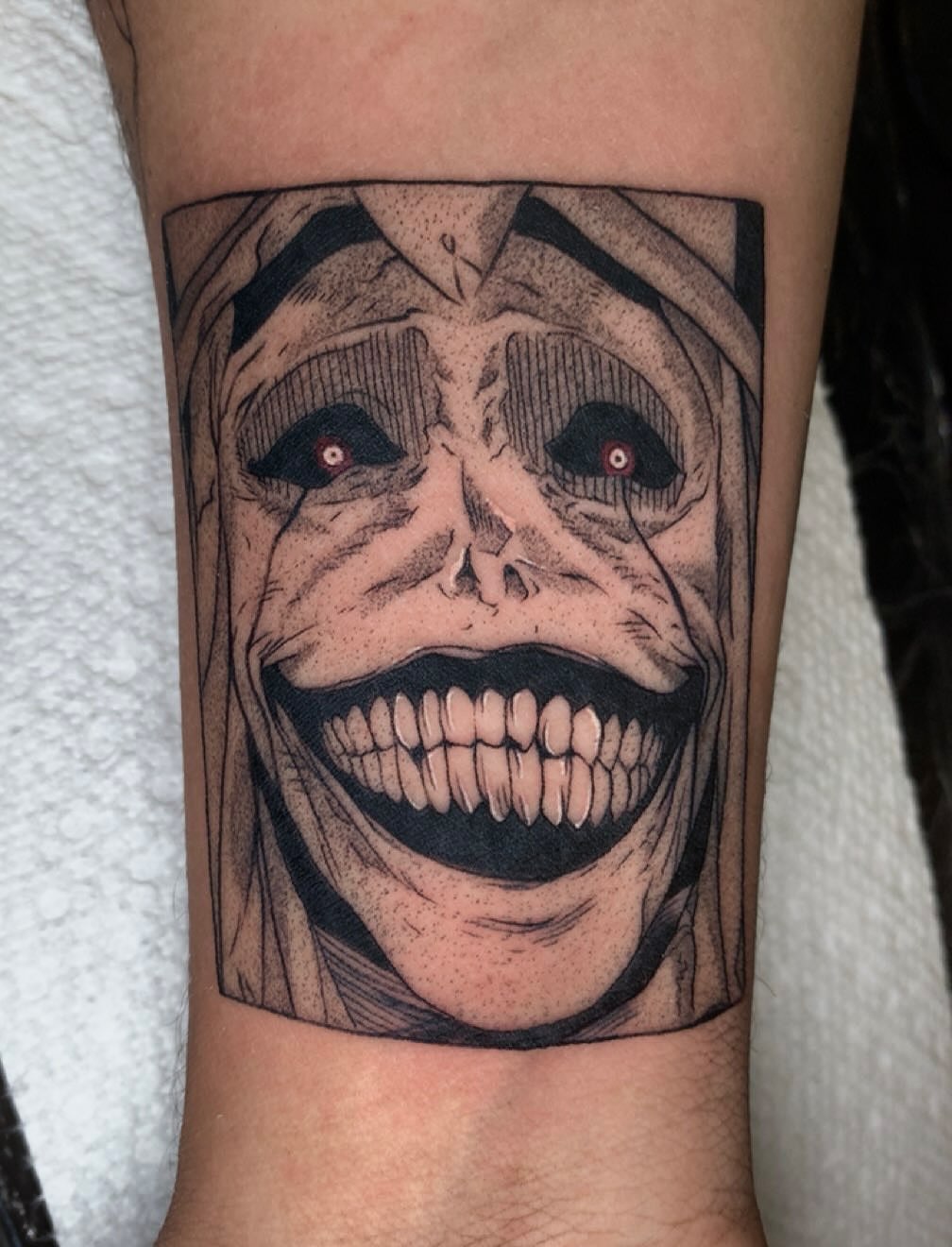 Grimace dark realism tattoo on the forearm by Maddie Rees