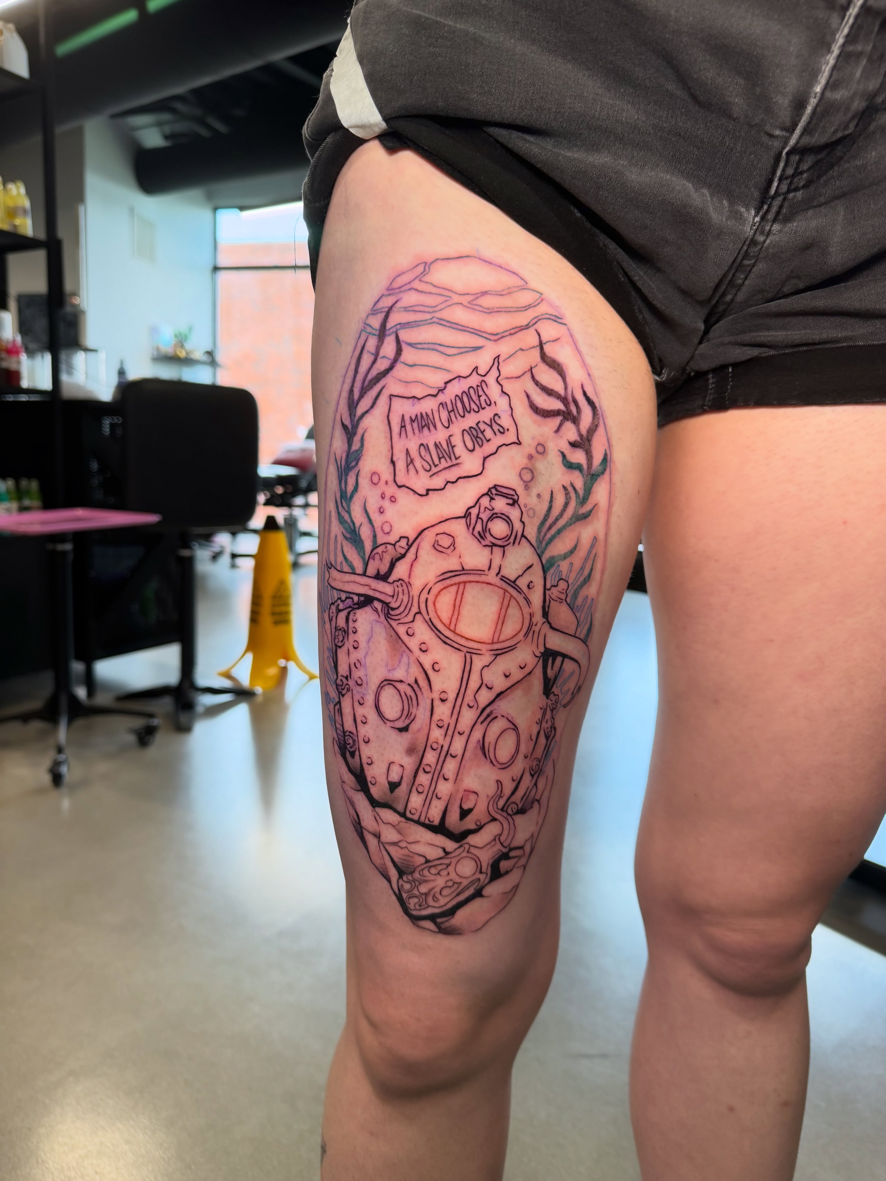 Diver in diving suit realism tattoo on the thigh by Derek Foferek, Charlotte, North Carolina