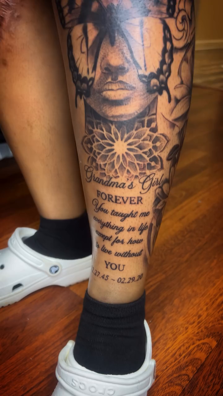Portrait with floral and script elements Chicano tattoo on the leg by Ed Forrest