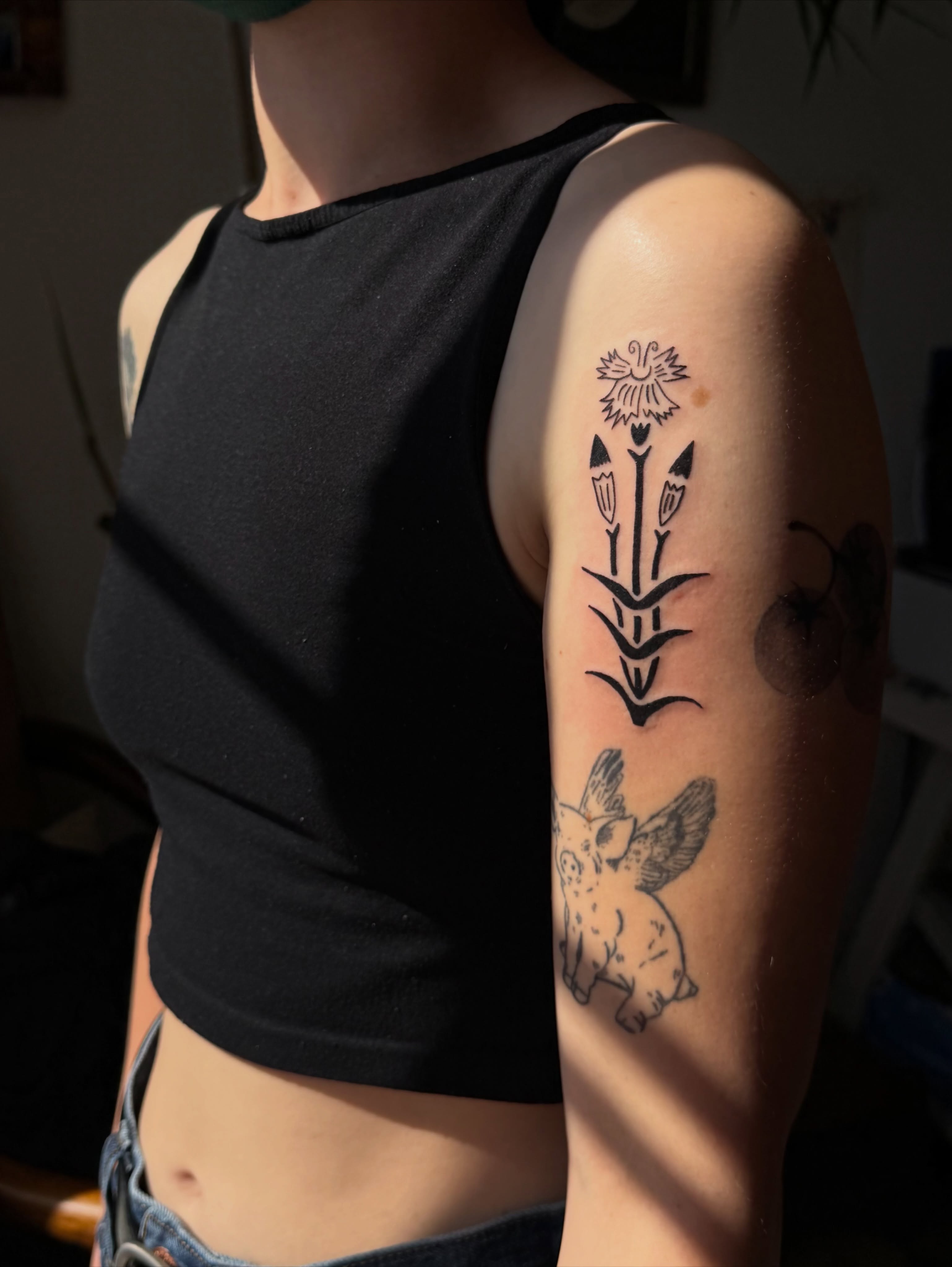 Flower and pig black and grey tattoo on the upper arm by ♤ Catherine Stengel ♤