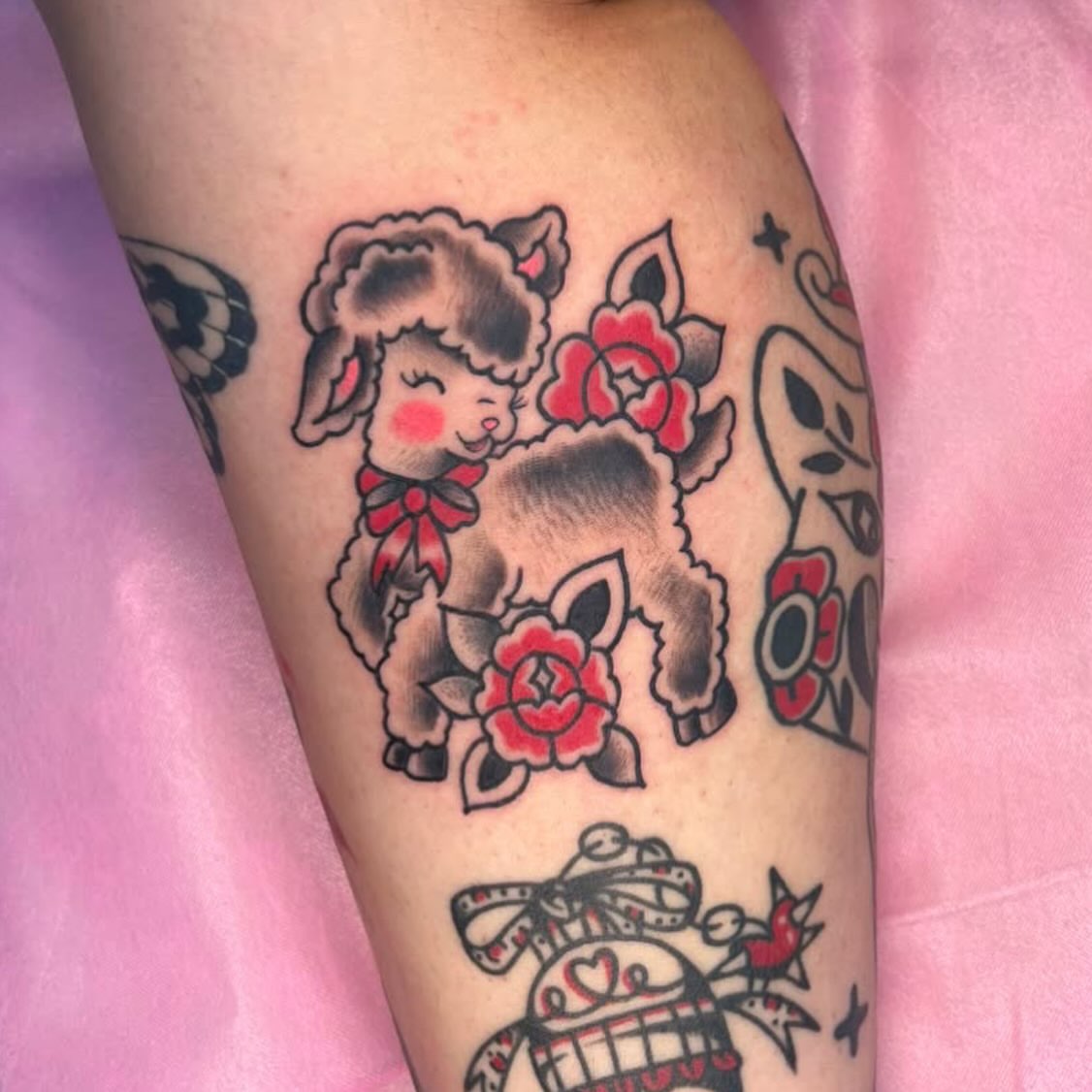 Sheep and roses American traditional tattoo on the forearm by seattle tattoo artist