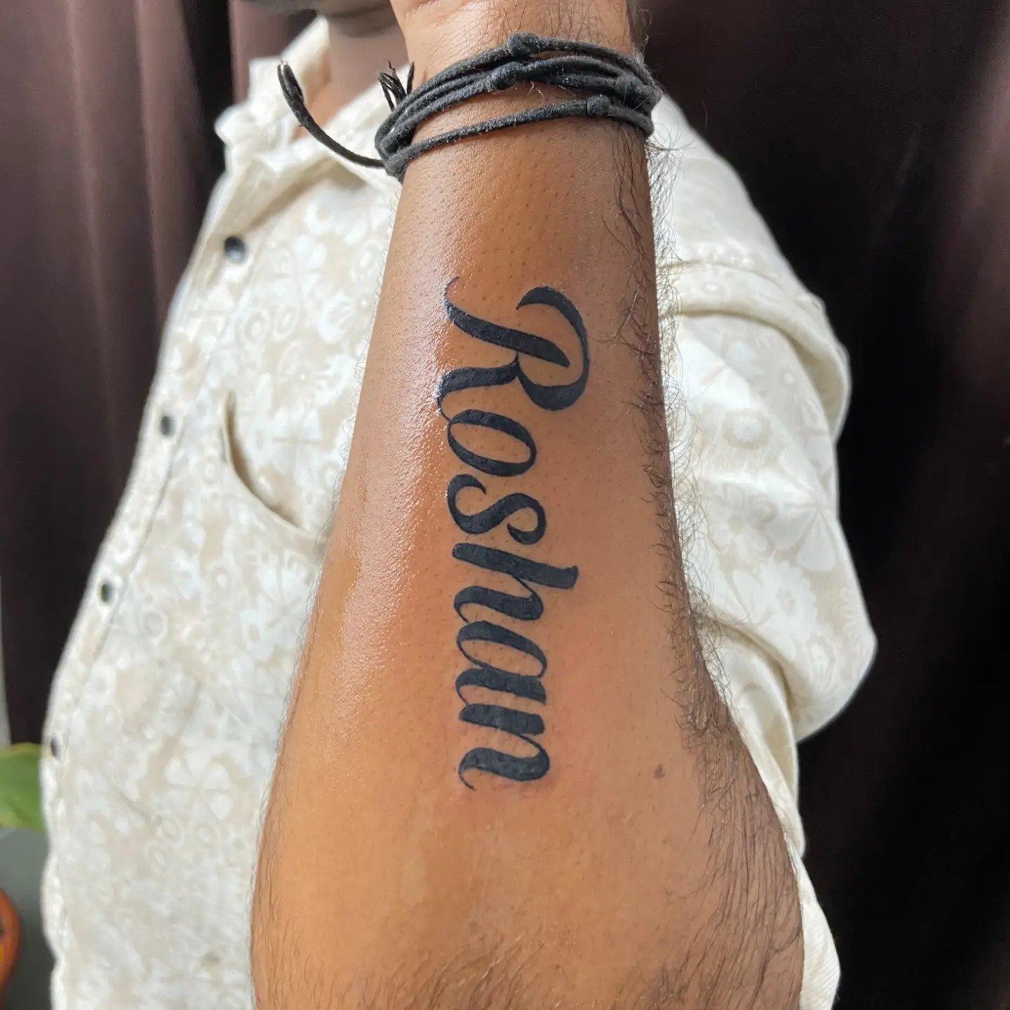 Roshan lettering script tattoo on the forearm by VR tattoo Studio