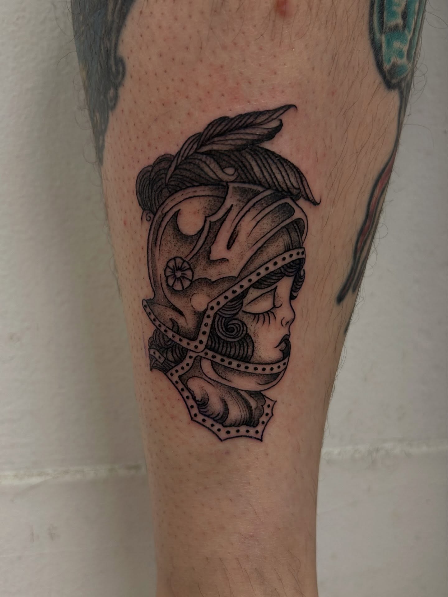 Helmeted warrior black and grey tattoo on the forearm by Chris