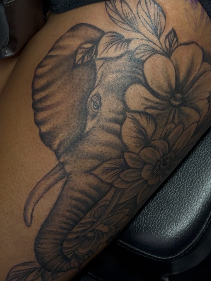 Elephant and flowers dotwork tattoo on the thigh by Betotats