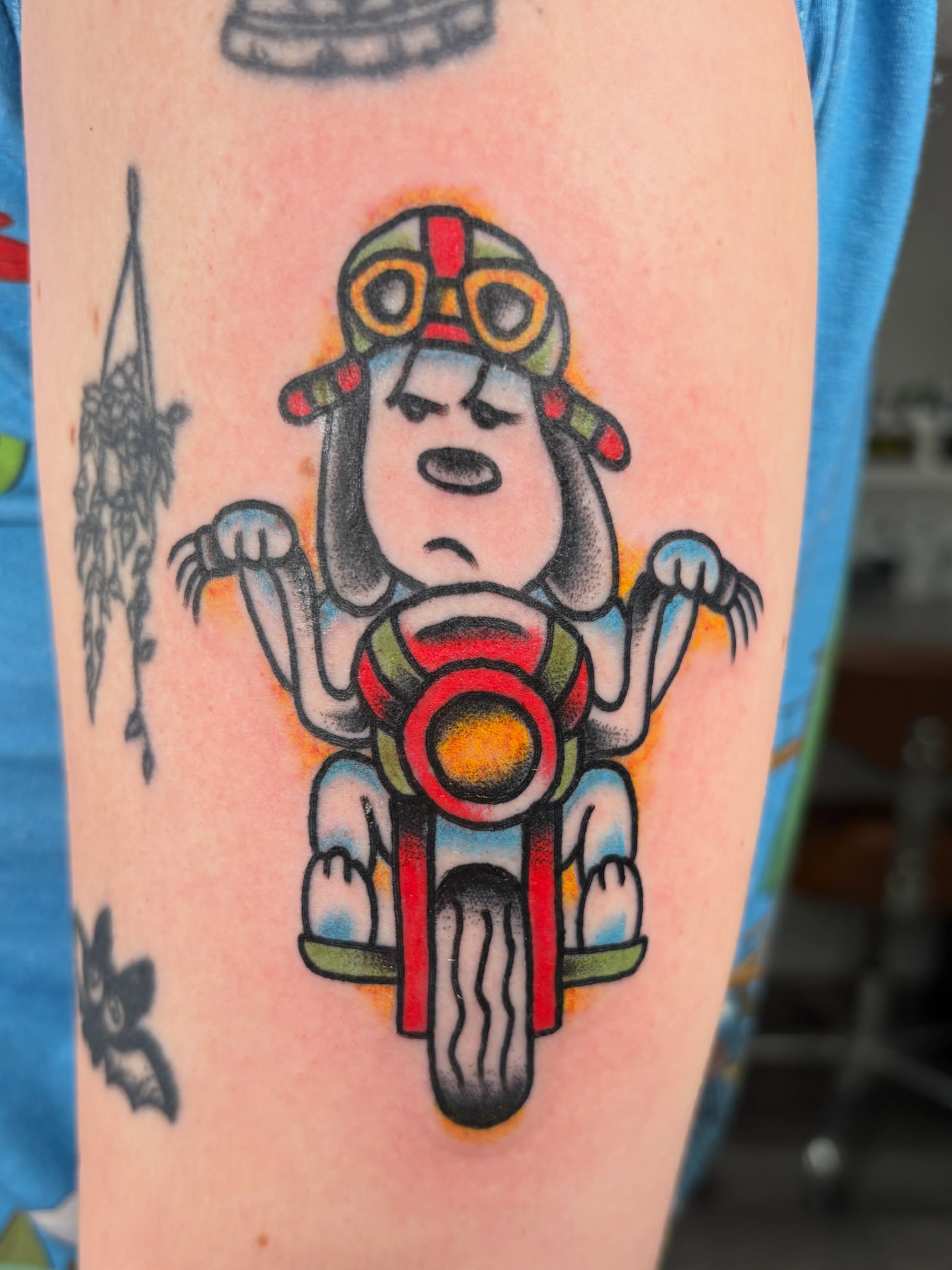 Snoopy on motorcycle American traditional tattoo on the forearm by Aysia Mankin-Wong, San Francisco, California