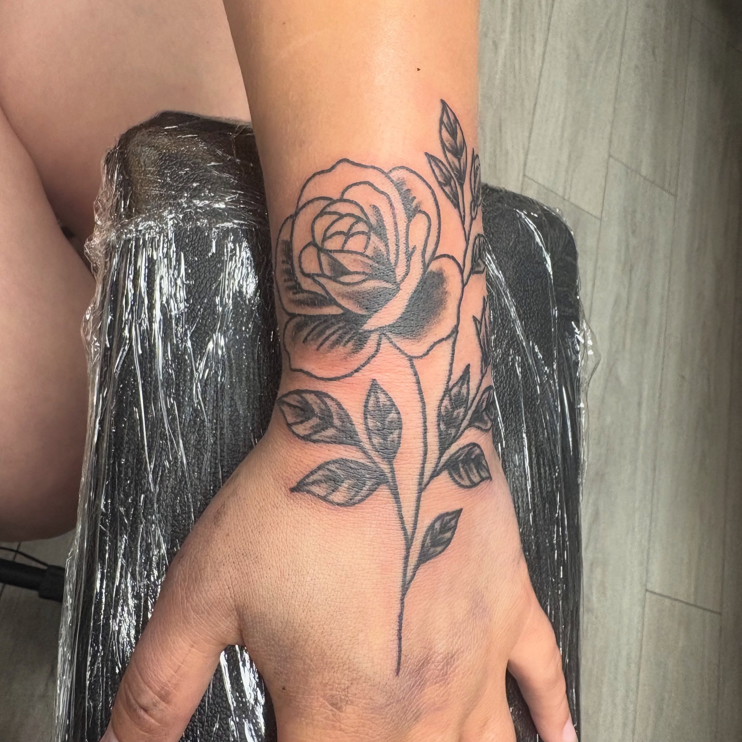 Rose black and grey tattoo on the forearm by Landon Bagley