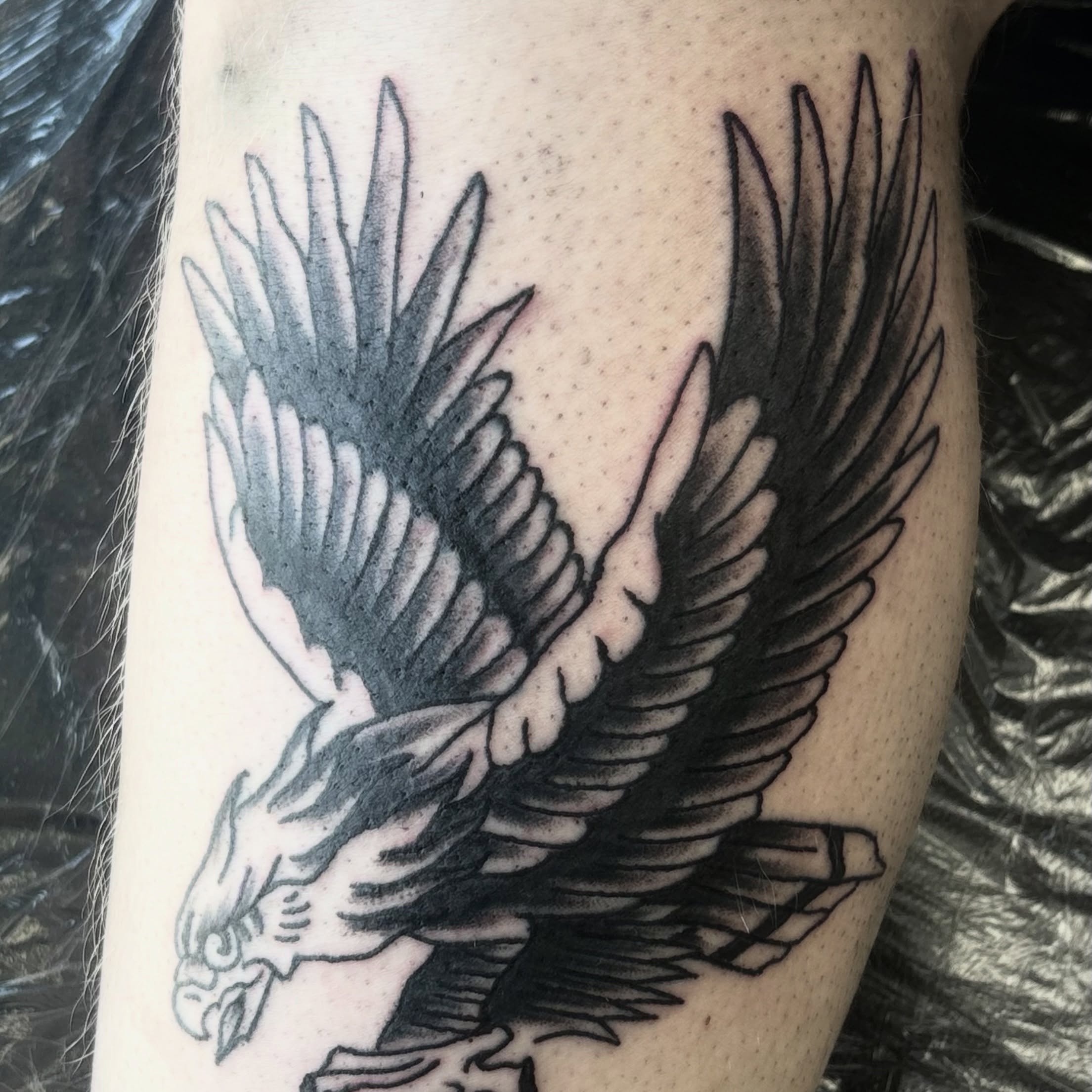 Eagle black and grey tattoo on the forearm by Landon Bagley