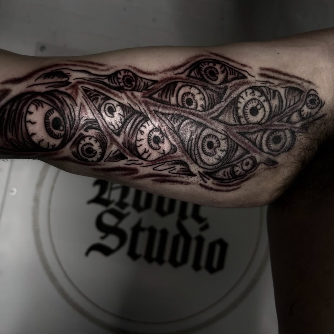 Eyes black and grey tattoo on the forearm by Landon Bagley