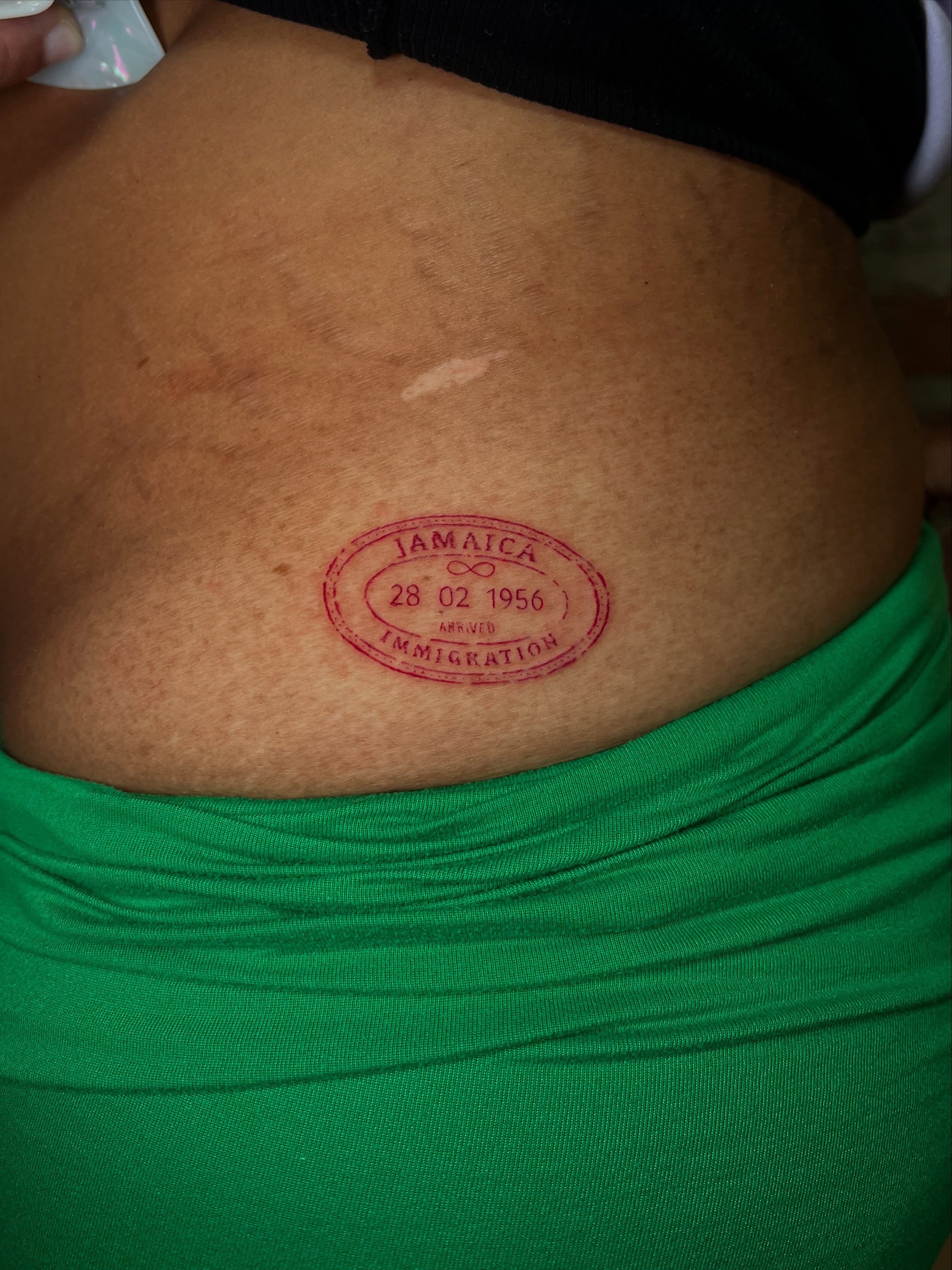 Passport stamp black and grey tattoo on the torso by Uncomfy Comfort Tattoos LLC