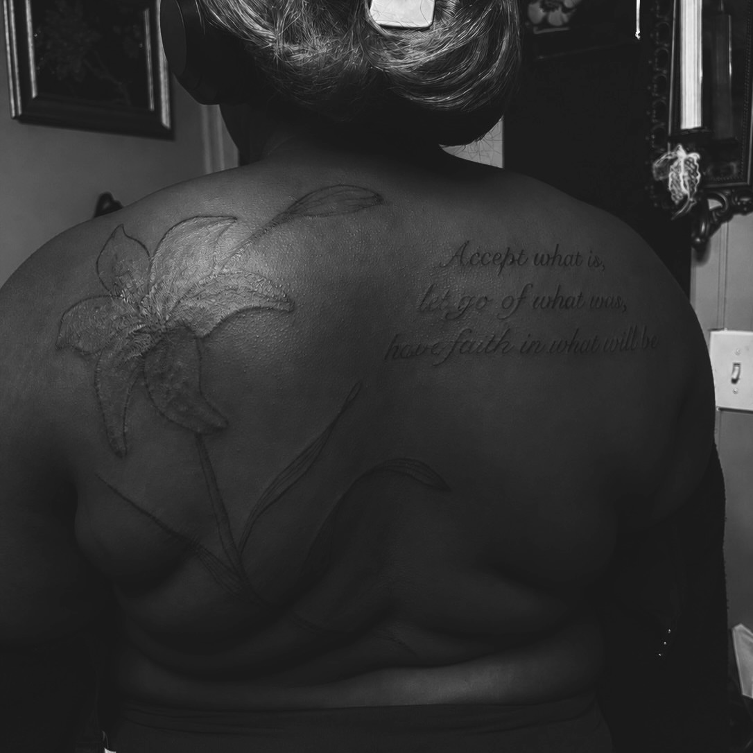 Flower and inspirational quote black and grey tattoo on the back by ⚜️Embodied Tattoo⚜️, Columbus, Ohio