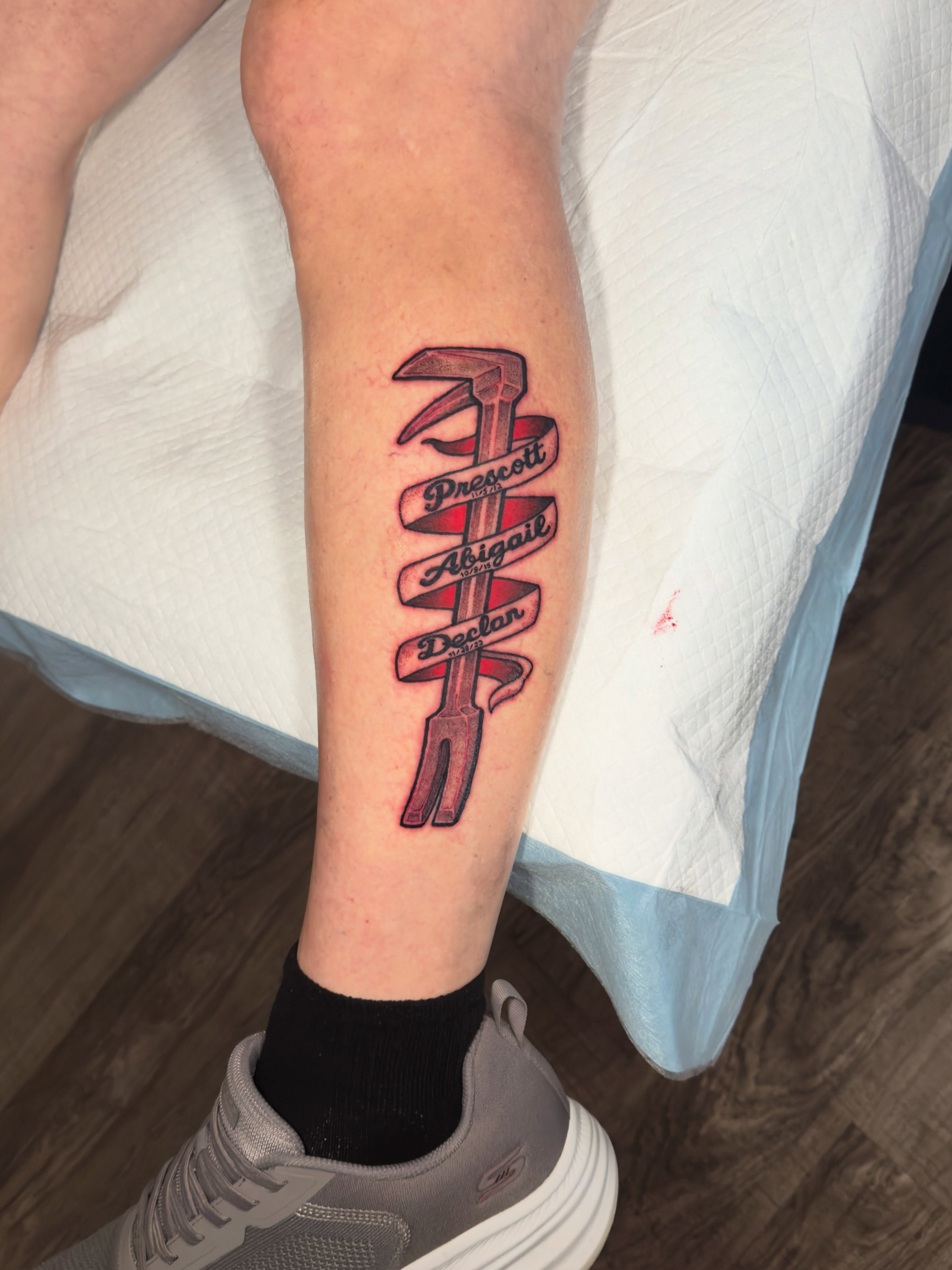 Family names lettering script tattoo on the forearm by Damon Moore