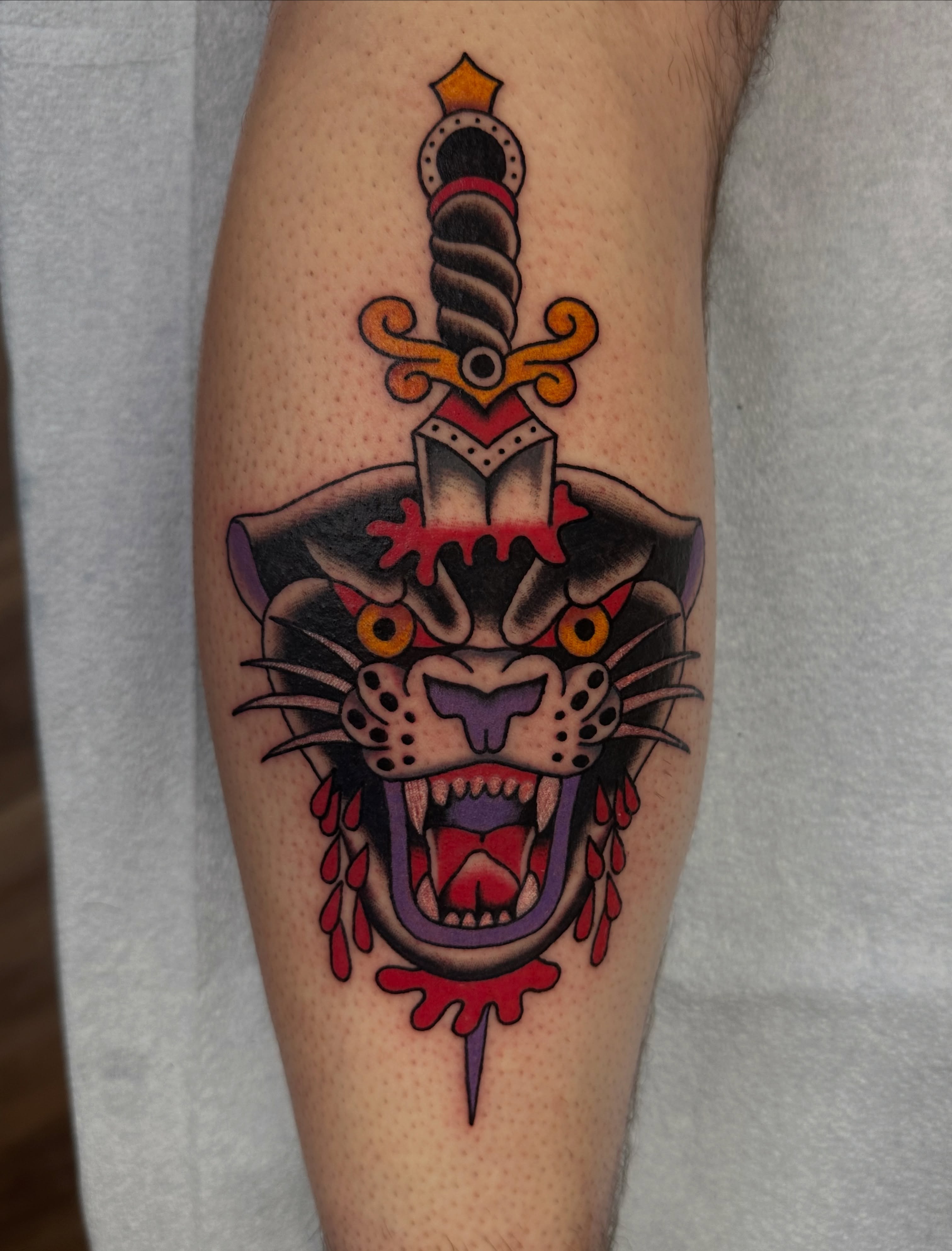 Panther and dagger American traditional tattoo on the forearm by Emily Masa