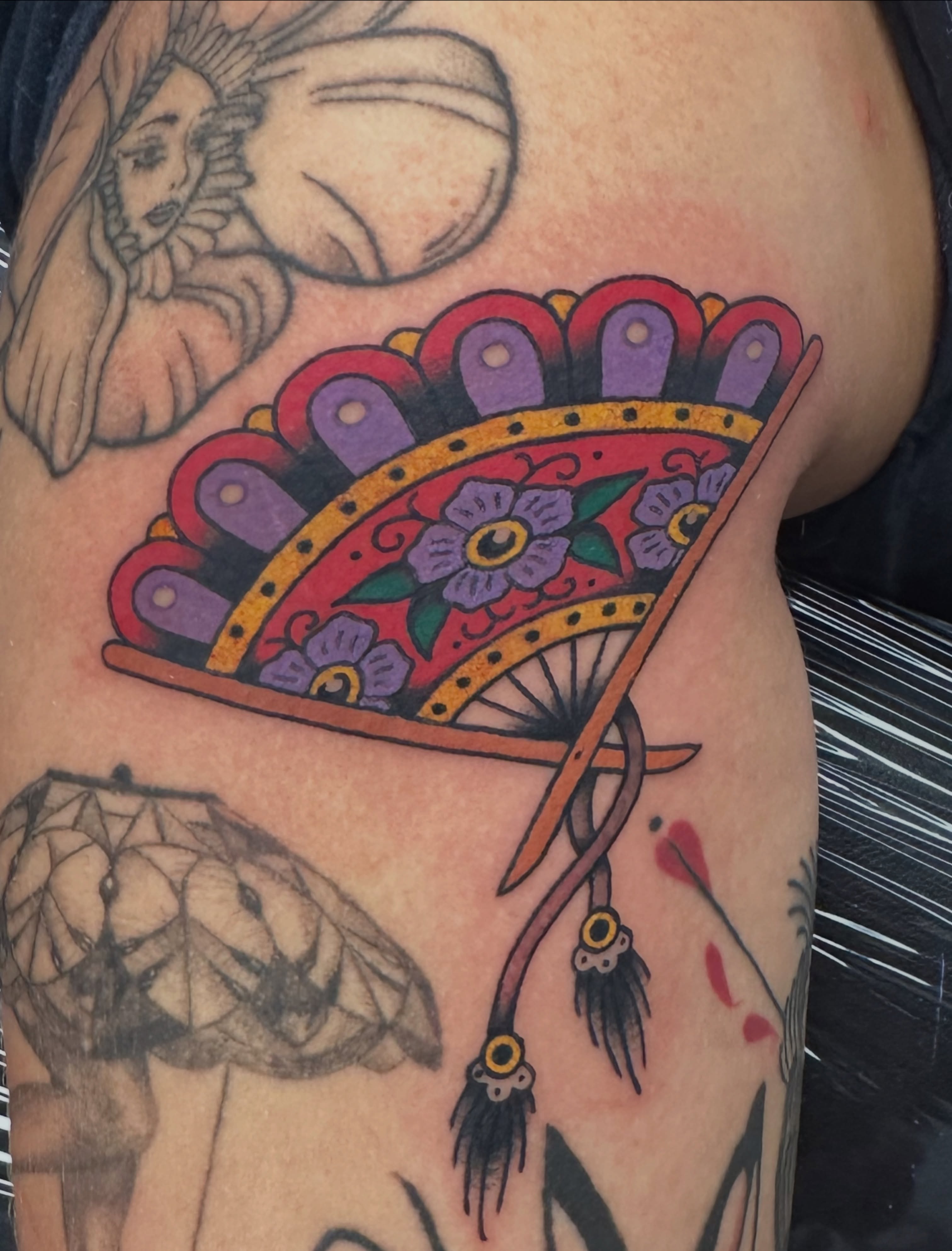 Fan Chicano tattoo on the shoulder by Emily Masa