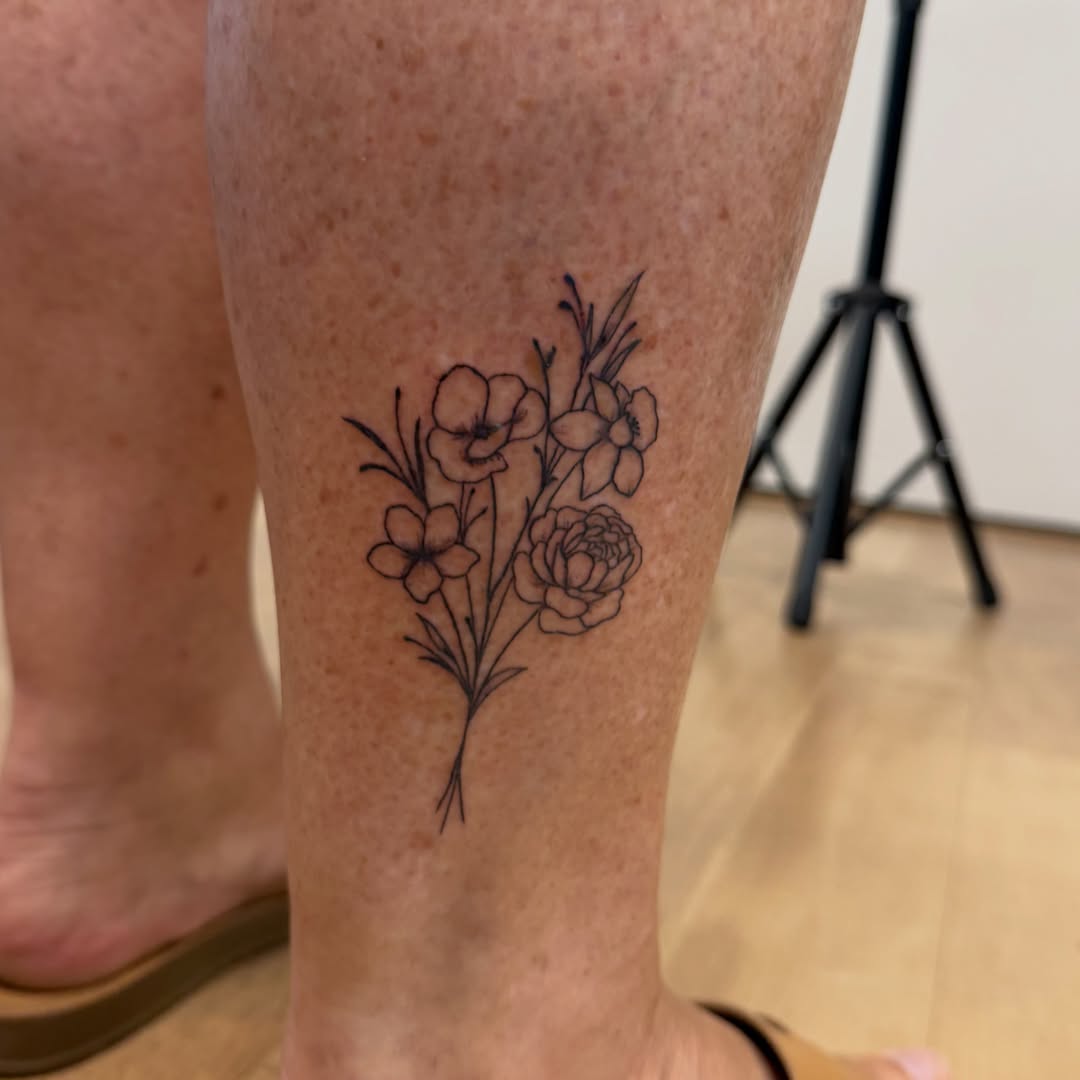 Flower bouquet black and grey tattoo on the calf by TolzinInk, Brookings, South Dakota