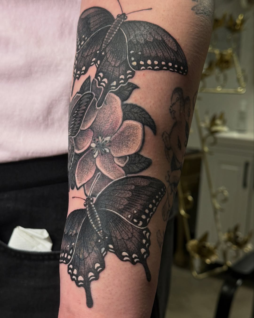 Butterfly and flowers realism tattoo on the forearm by Christian