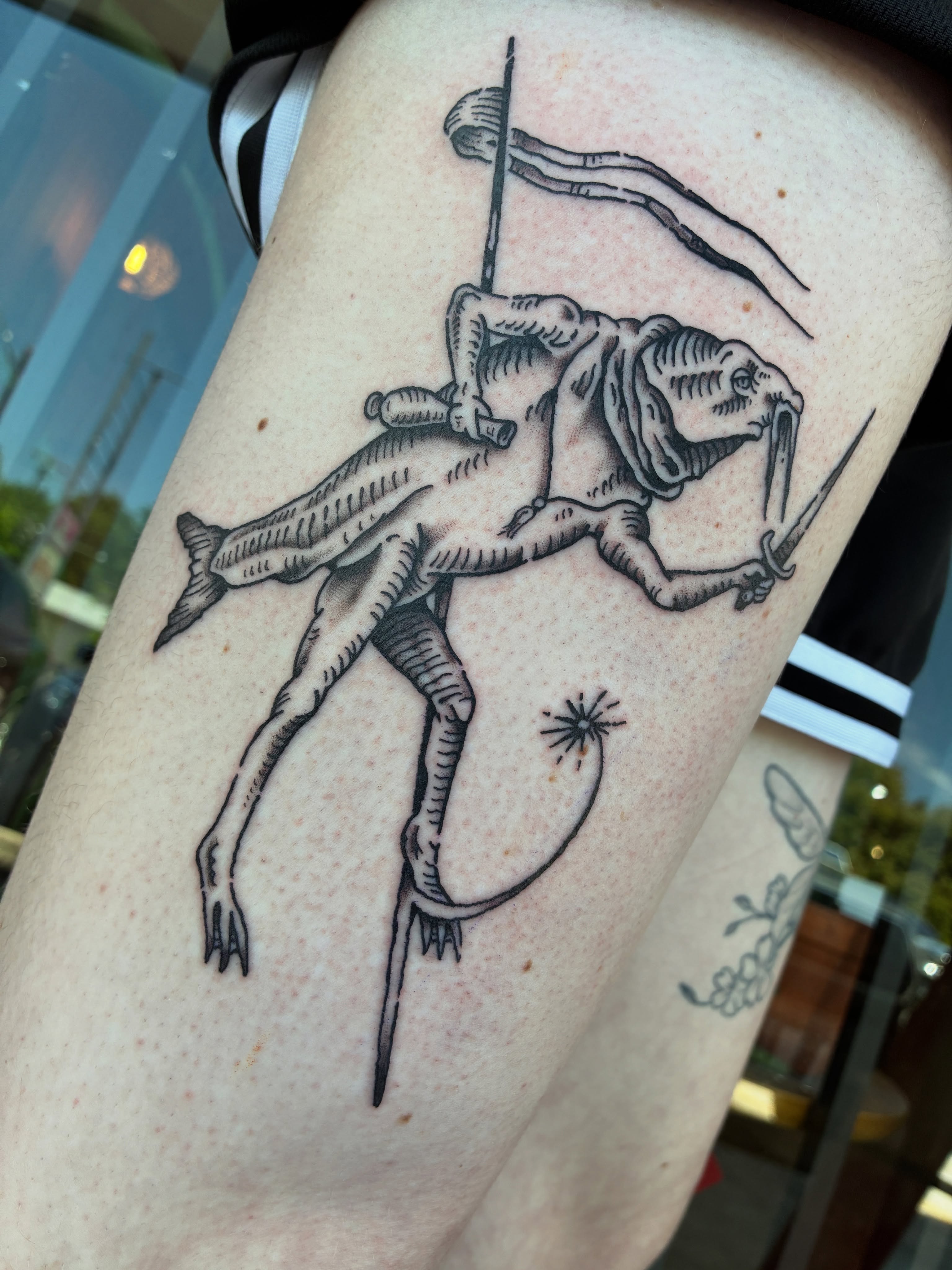 Frog with spear black and grey tattoo on the thigh by Zachary R Bobkoff